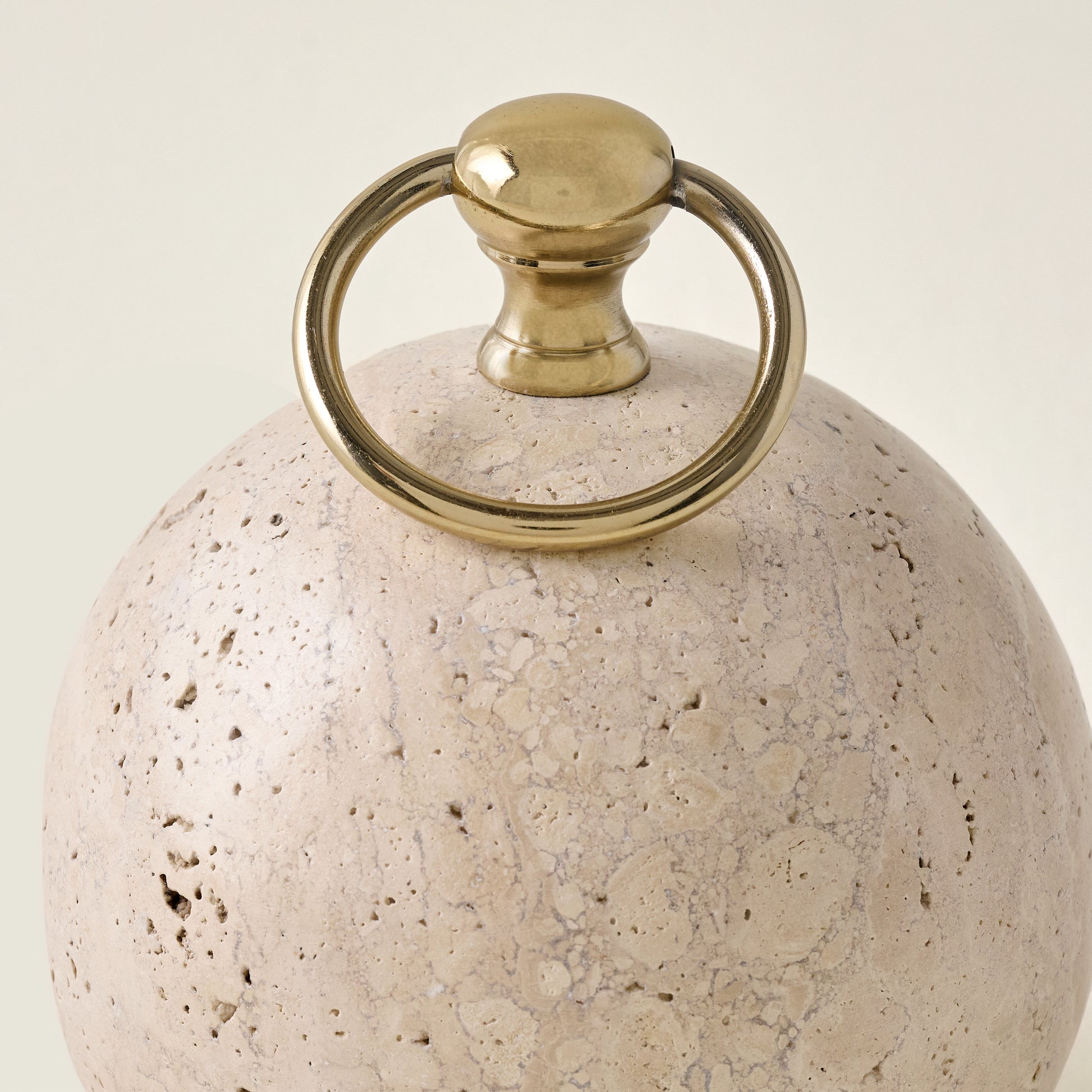 Travertine and Brass Doorstop up close