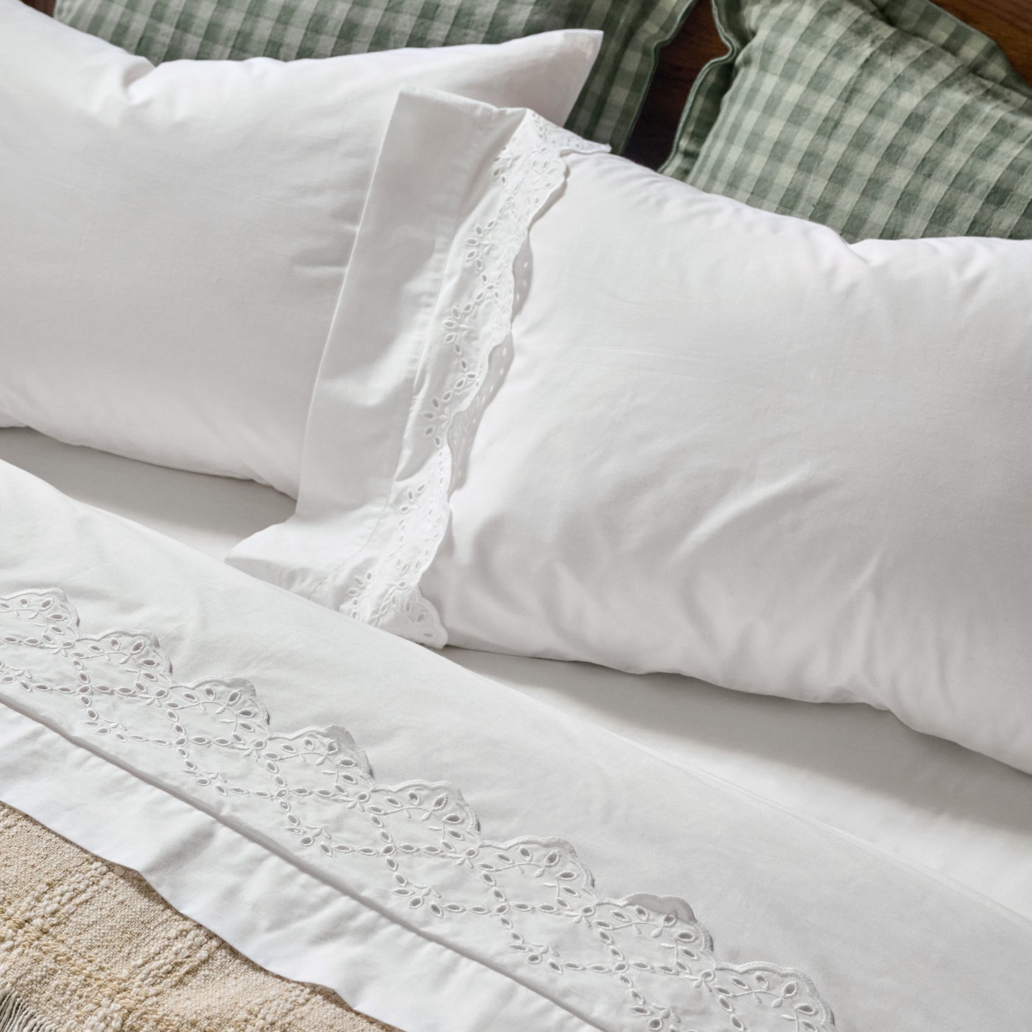 Eyelet Scallop Edge Sheet Set on a bed