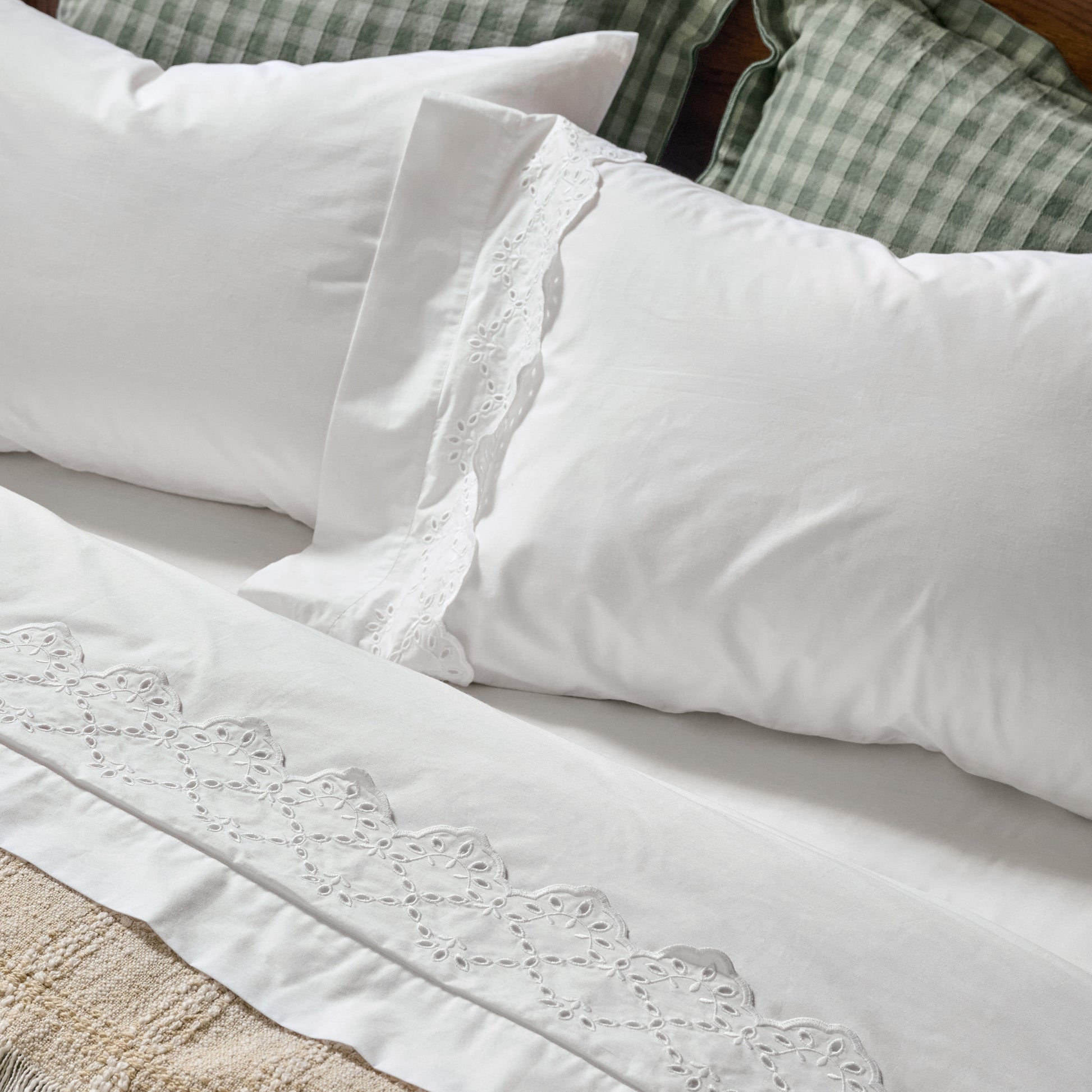 Eyelet Scallop Edge Sheet Set on a bed