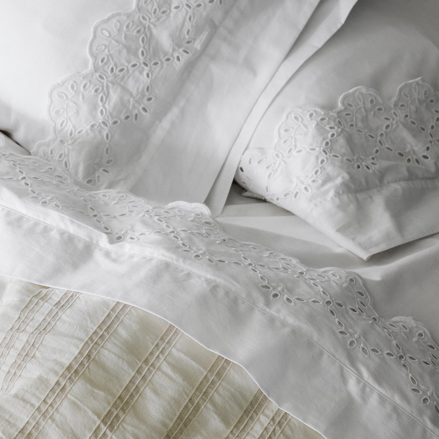 Eyelet Scallop Edge Sheet Set on a bed