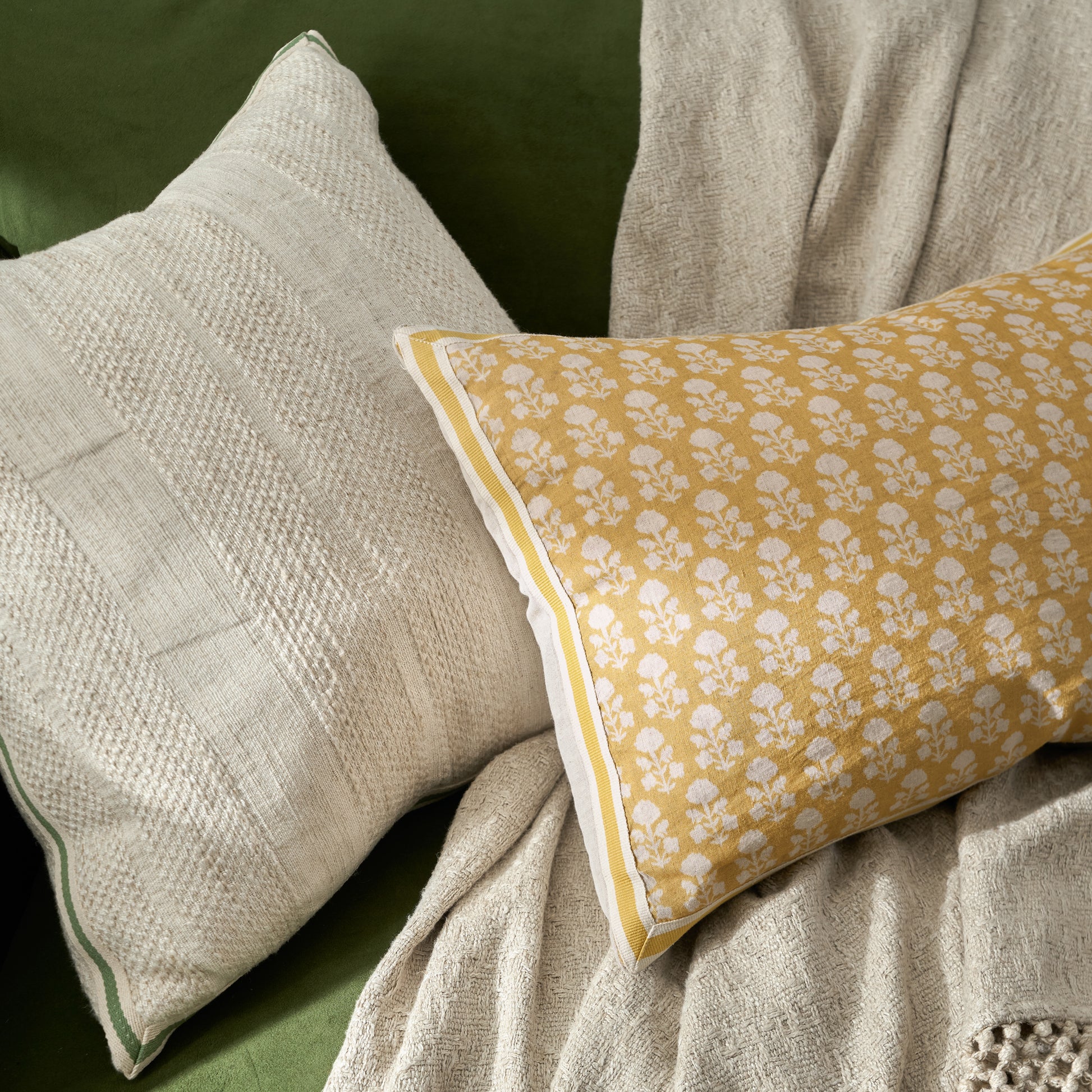 Ellie Block Print Pillow shown on couch up close with other pillow + throws
