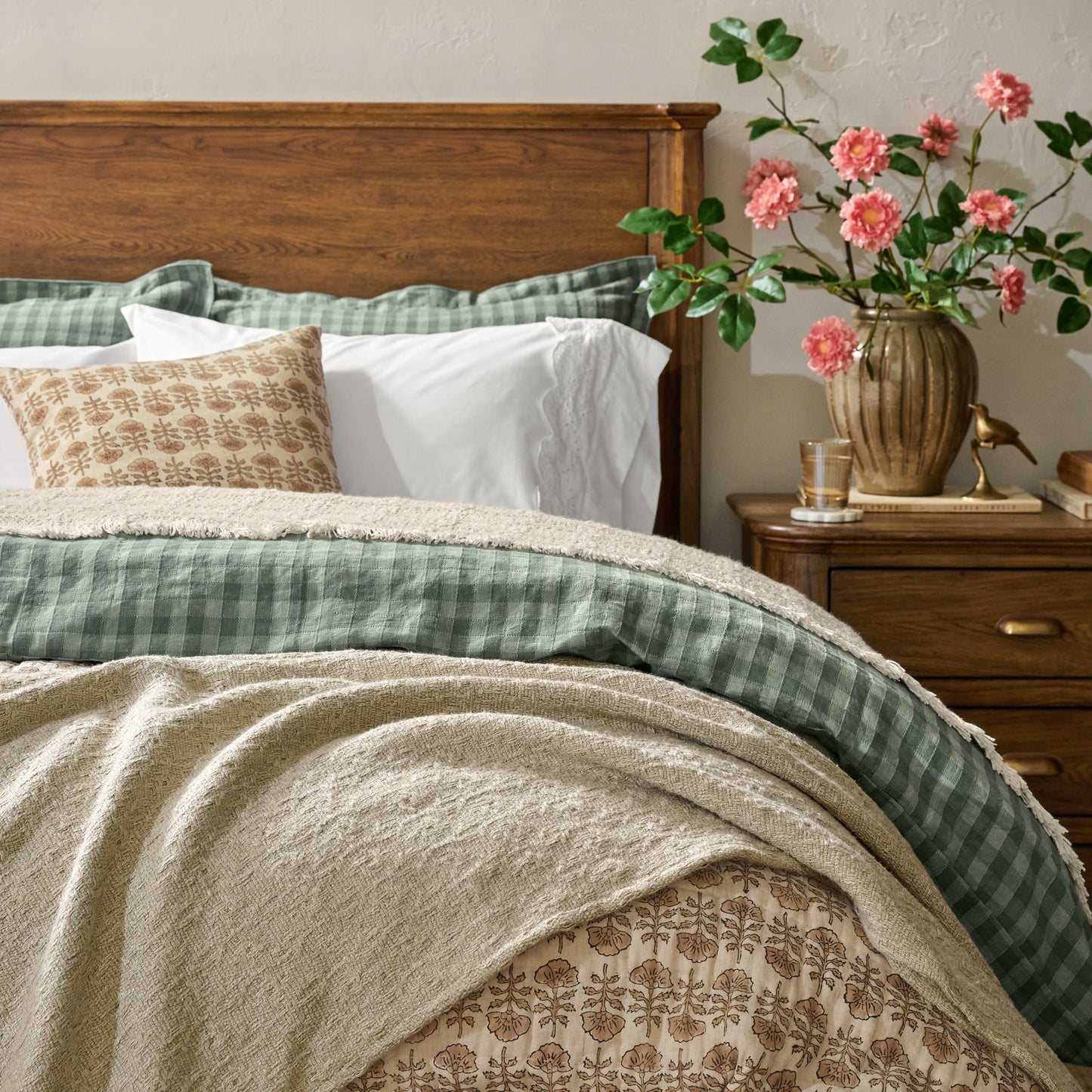Summer Tassel Throw shown draped over end of bed