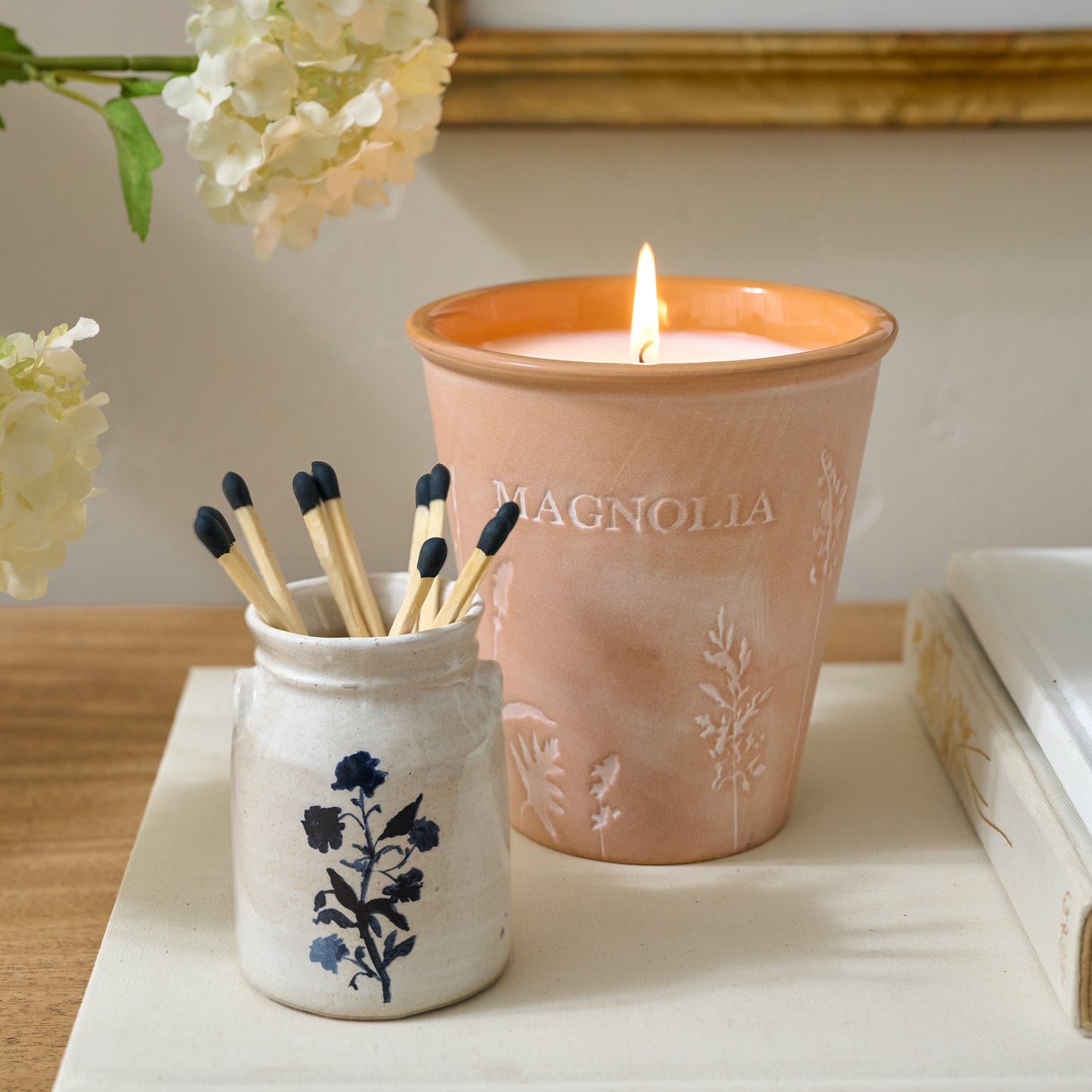 Magnolia Sun-Drenched Fig Garden Pot Candle shown with matches and mini crock