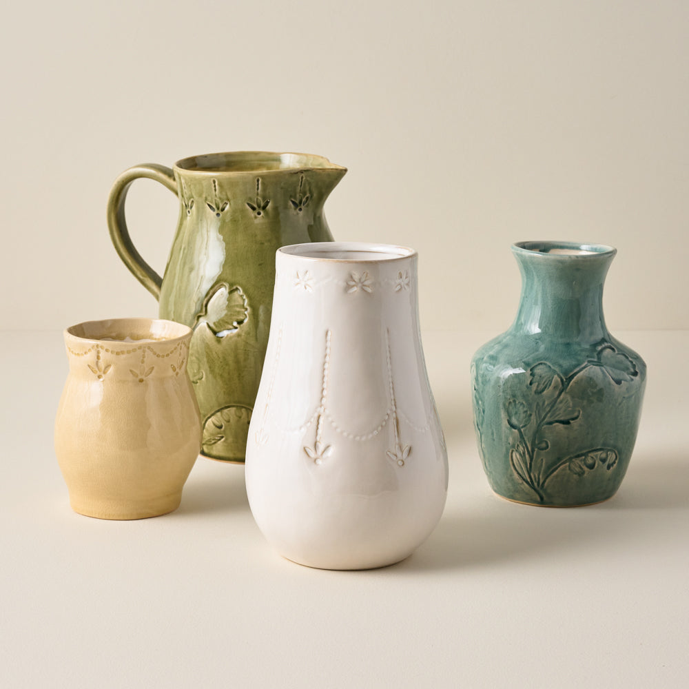 Floral Glazed Ceramic Birdie Vase shown with other ceramic vessels