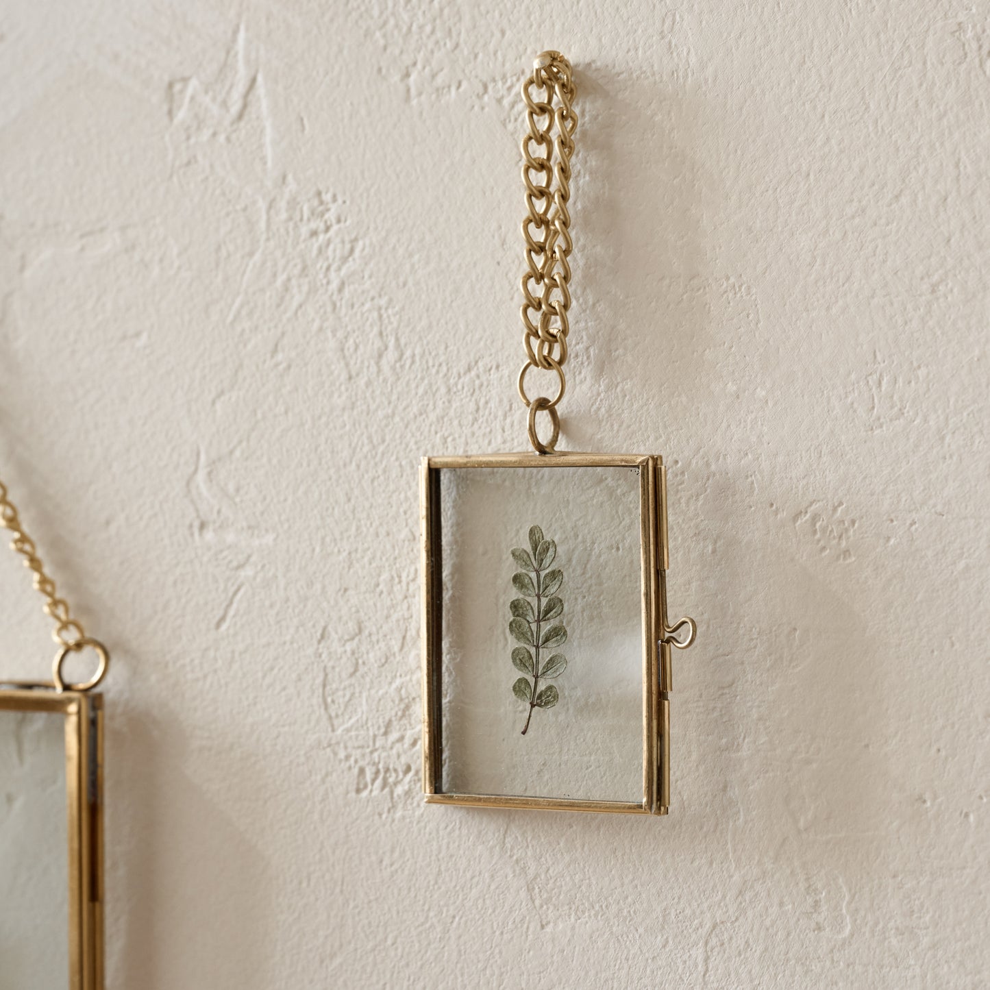 Mini Josie Hanging Brass Photo Frame shown hung on wall