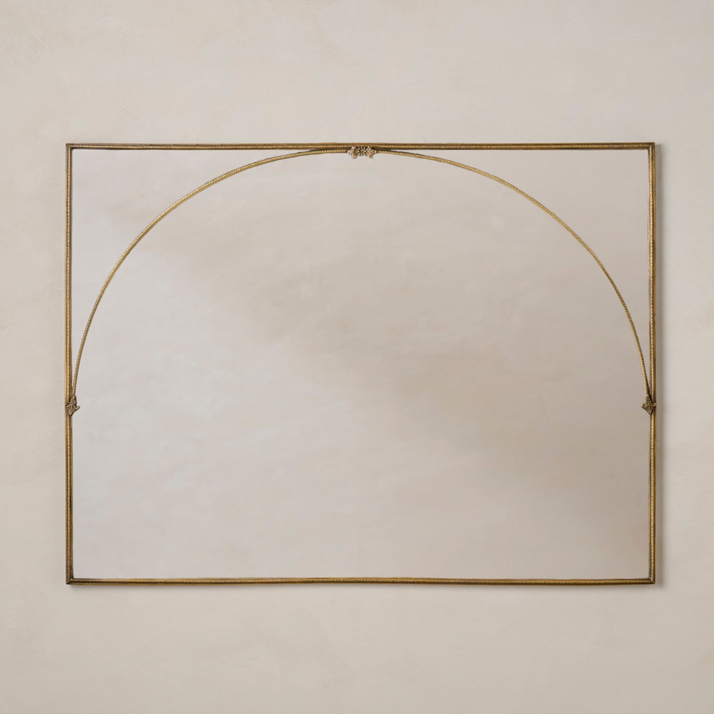 Decorative Vienna Mantle Mirror with a gold frame on a beige wall