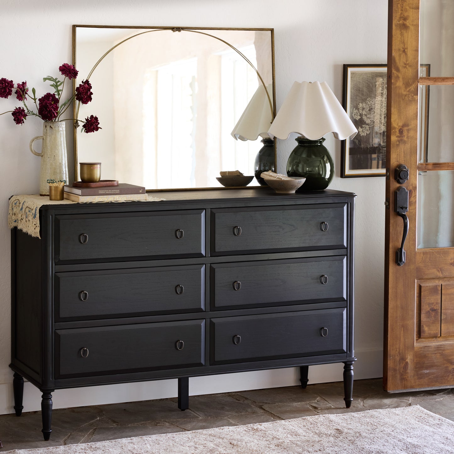 Vienna Mantle Mirror hung over black dresser in entryway