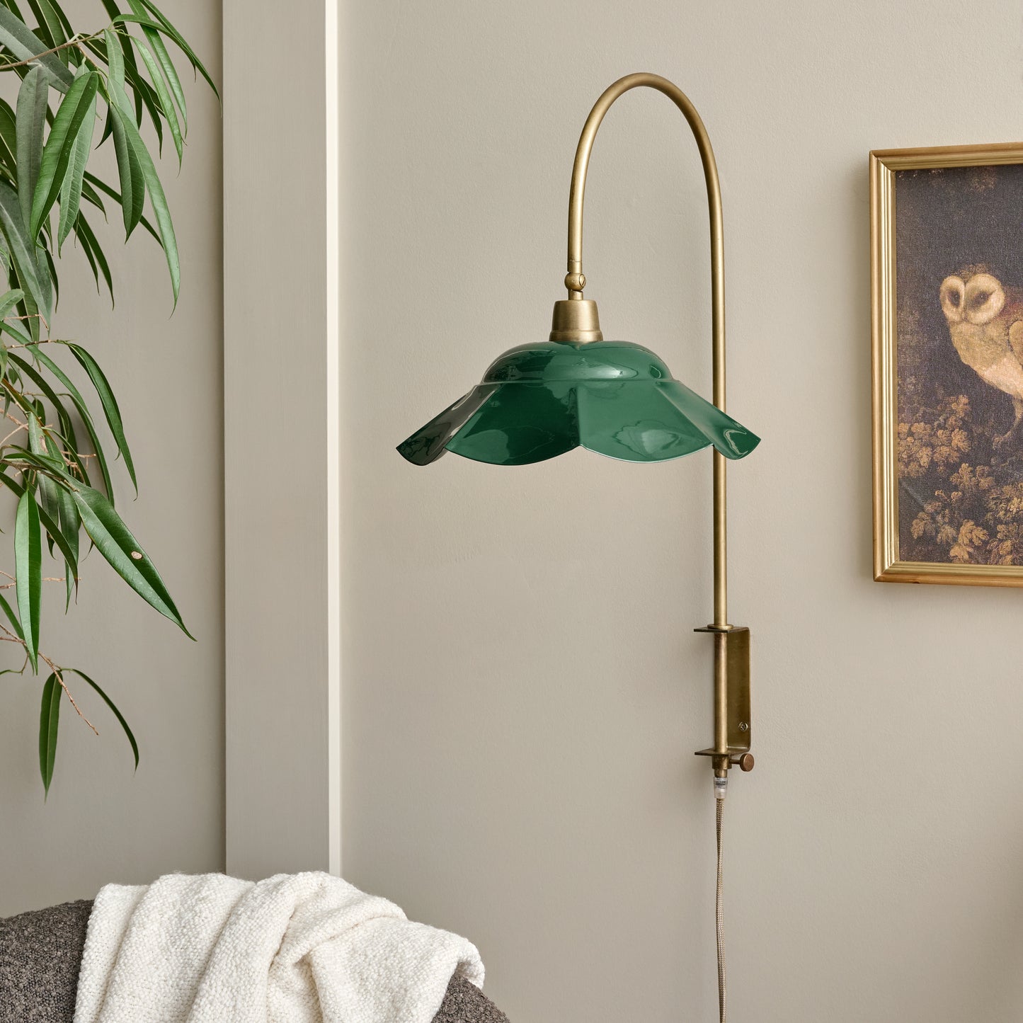 Mary Enamel Plug-in Sconce Dark Green with Brass shown on wall
