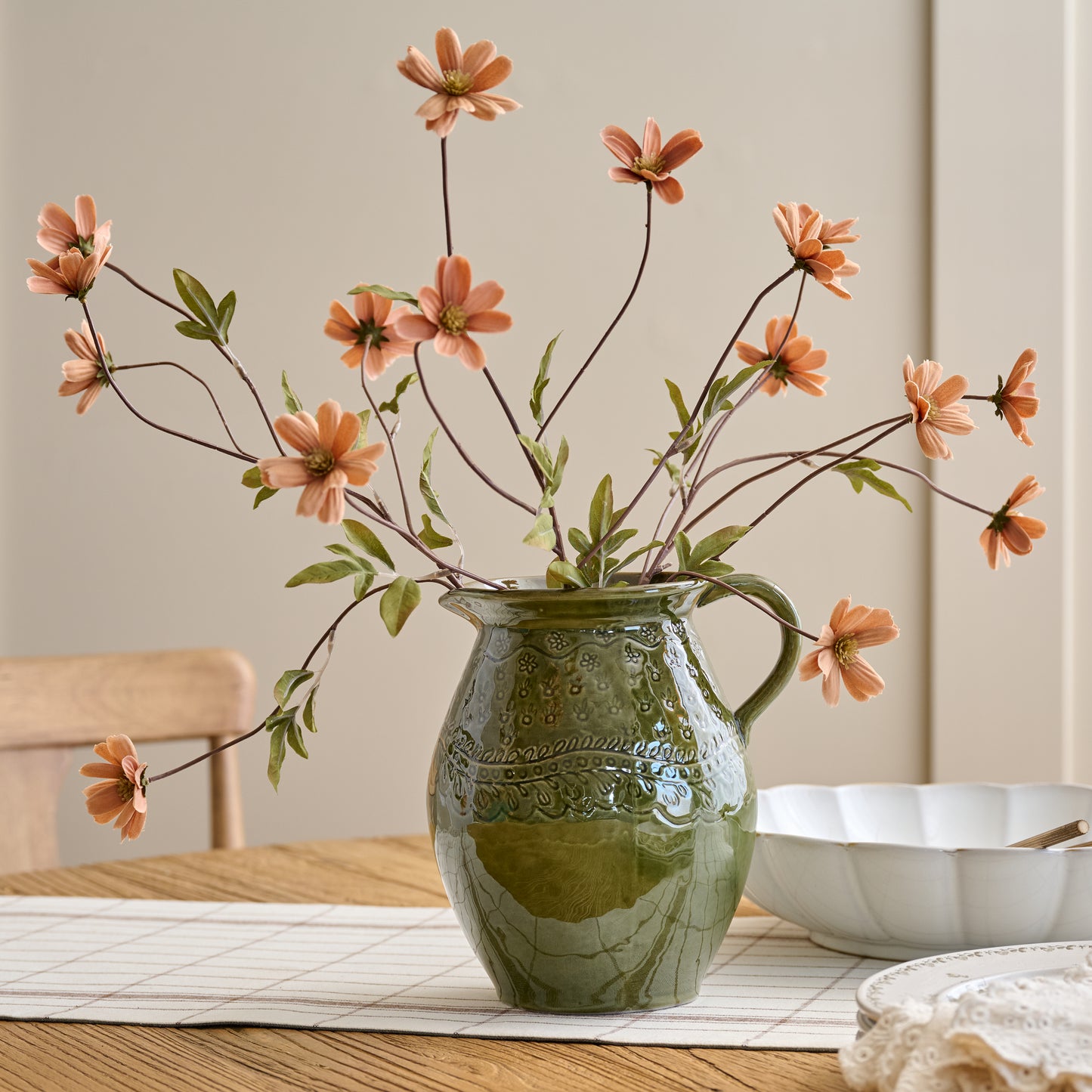 Light Amber Cosmos Stem shown in green vase on dining room table