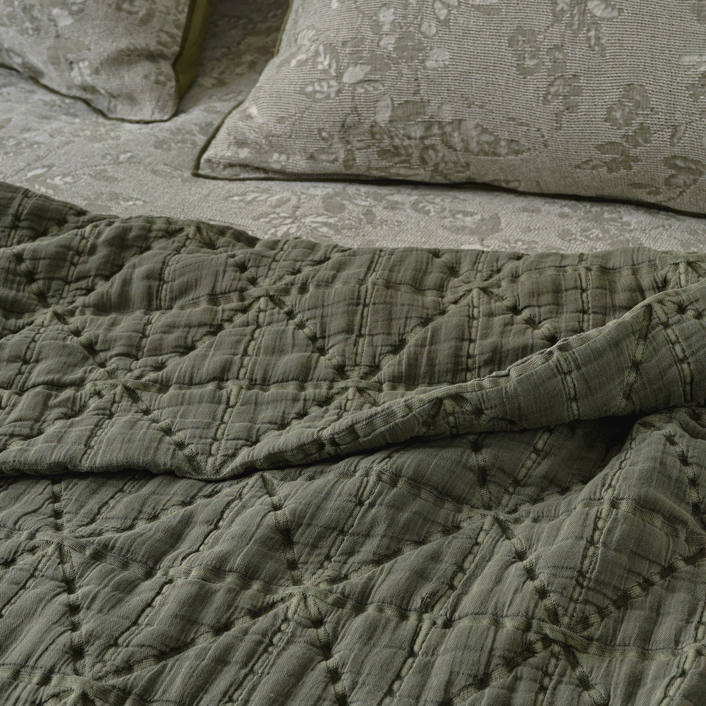 Sutton Winter Moss Matelasse Coverlet shown on bed up close