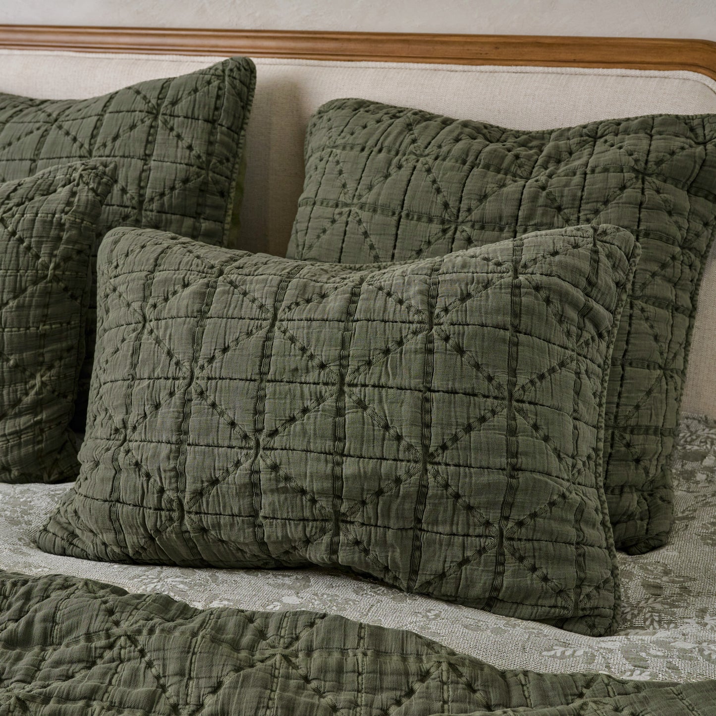 Sutton Winter Moss Matelasse Shams shown on bed