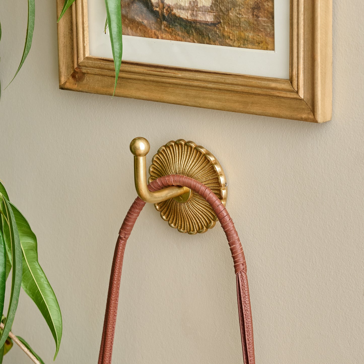 Shiloh Solid Brass Wall Hook shown styled on wall