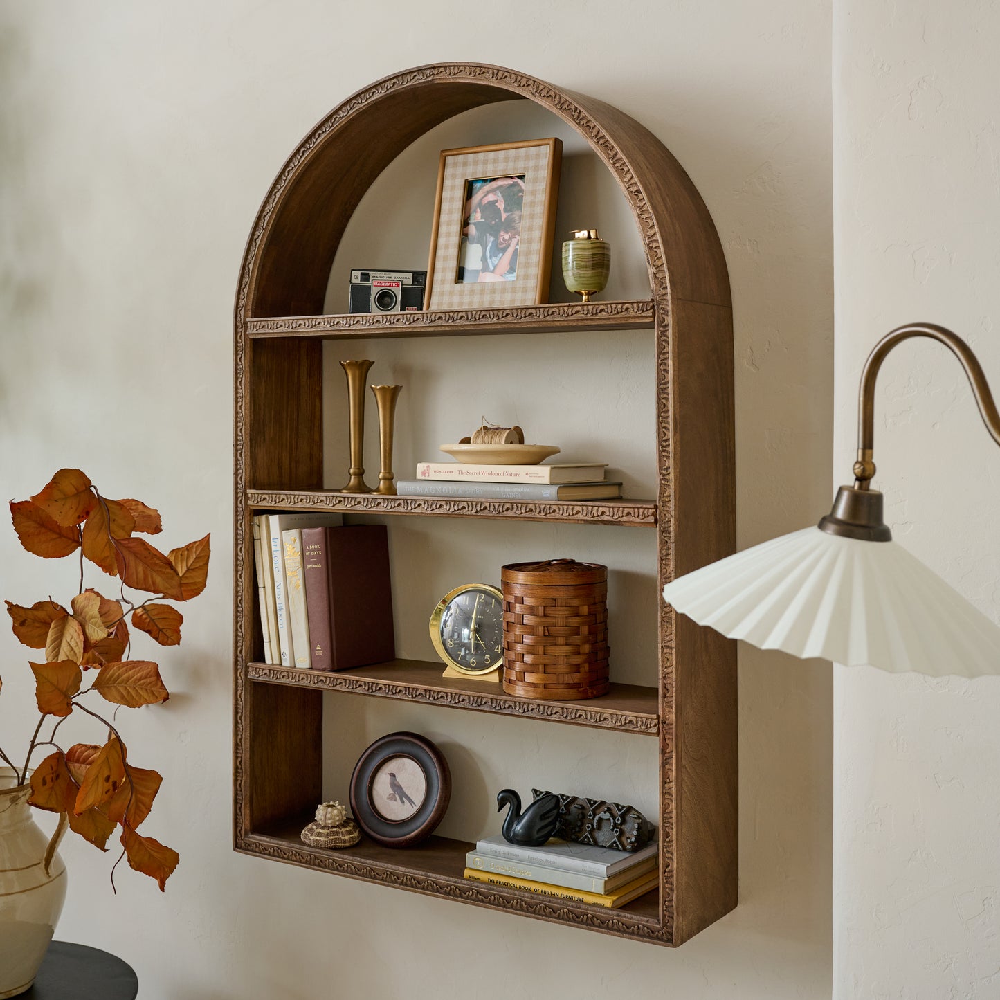 Hand Carved Wooden Archer Shelf shown styled on wall