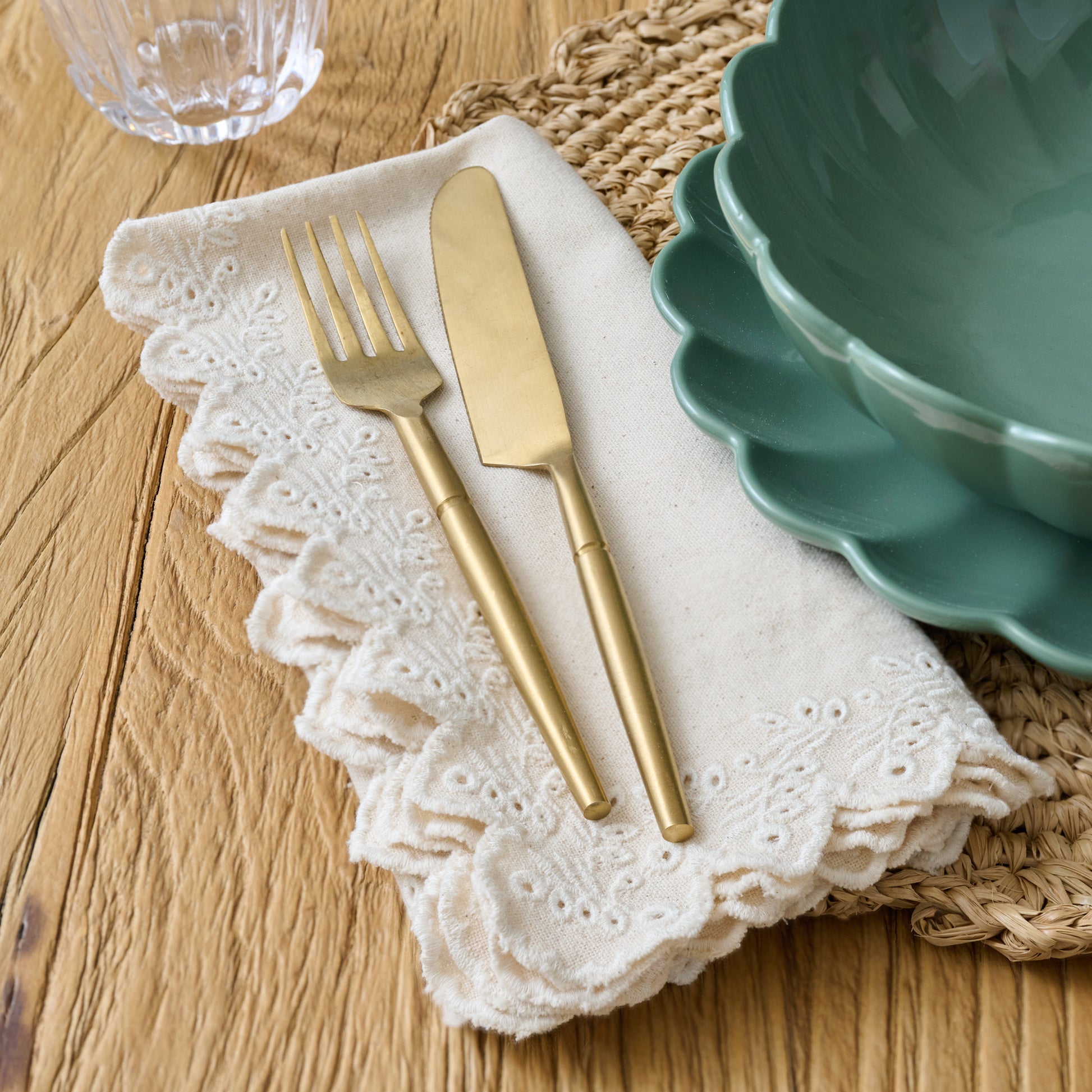 Oatmeal Embroidered Scalloped Edge Napkin set of Four shown on table with silverware