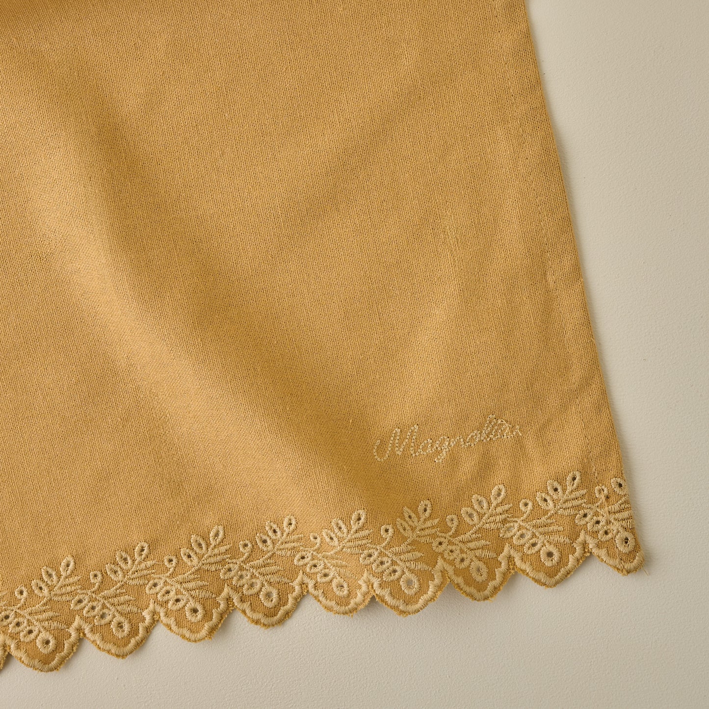 Magnolia Golden Scalloped Tea Towel corner up close