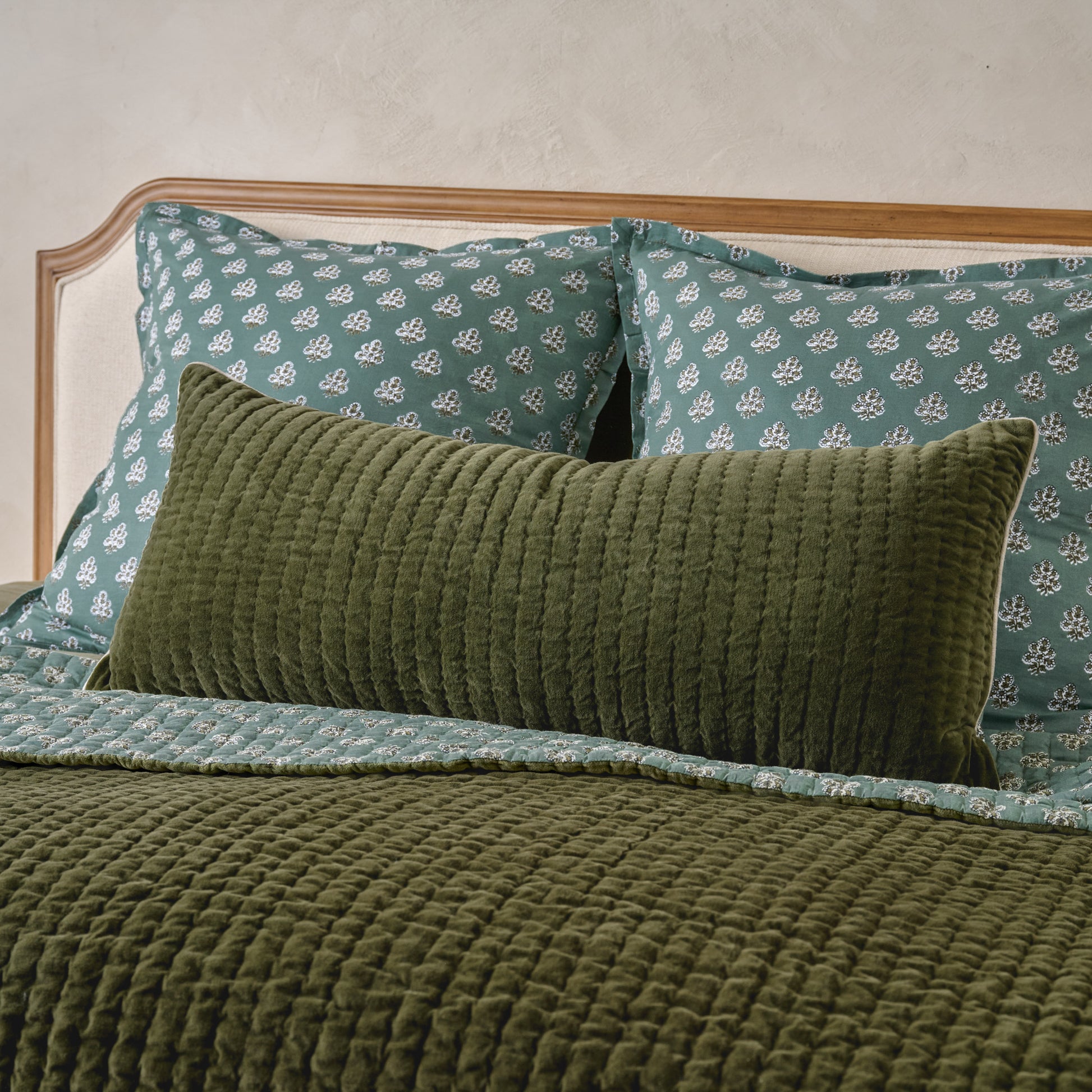 Audrey Velvet Lumbar Pillow- Winter Moss shown on bed