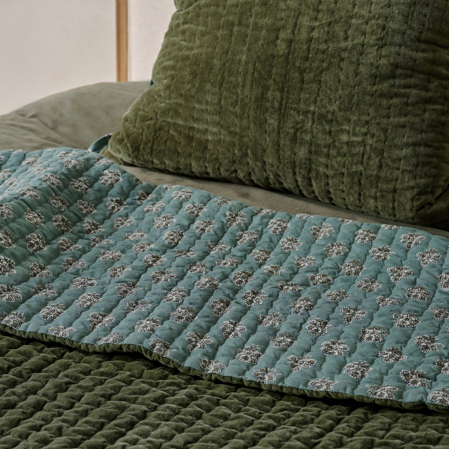 Audrey Velvet Block Print Quilt - Winter Moss shown on bed turned to show reversible sides