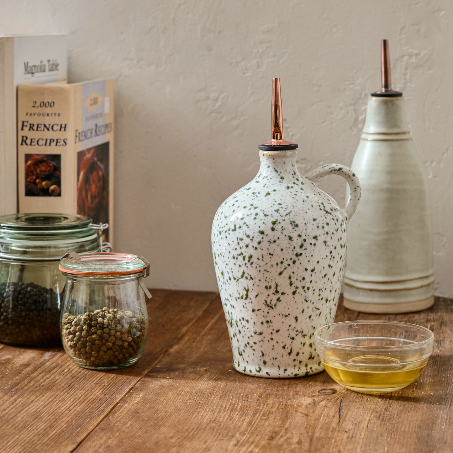 The Cottage Collection Speckle Oil Pour shown on kitchen counter