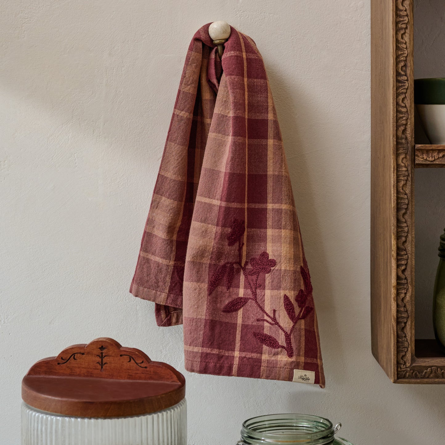 Maisley Floral Embroidered Tea Towel shown hung on wall hook