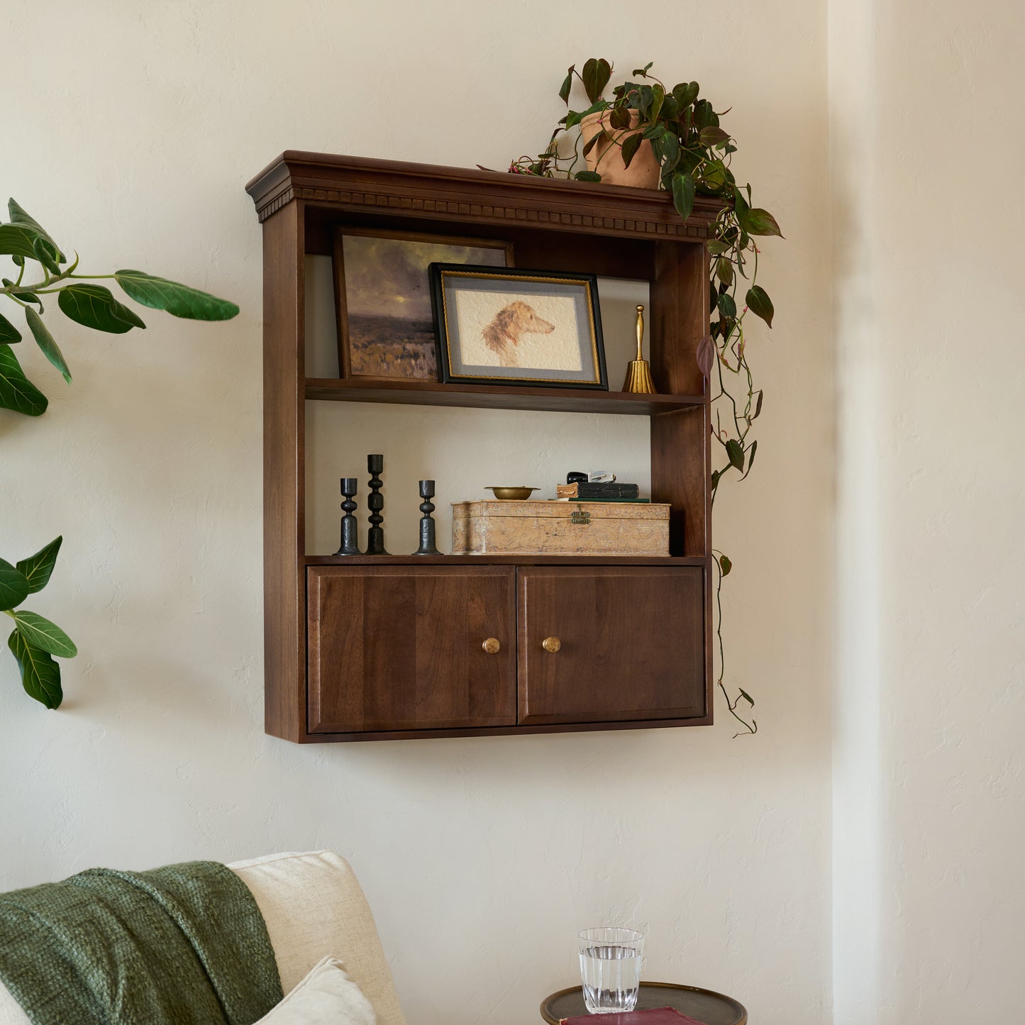 Dylan Wall Shelf with Doors shown styled on a wall