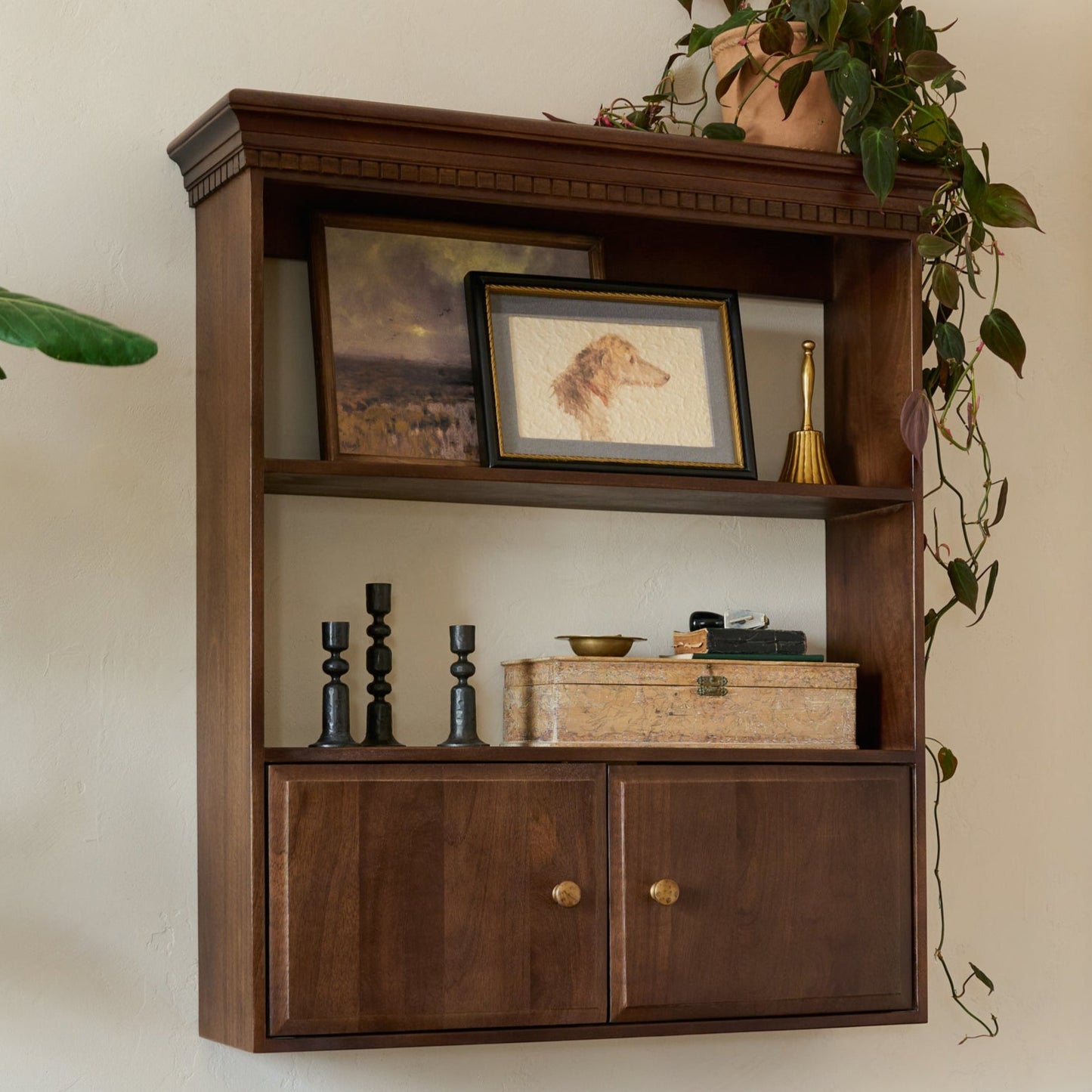 Dylan Wall Shelf with Doors shown styled on a wall