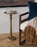 Antiqued Brass Cocktail Table shown next to accent chair