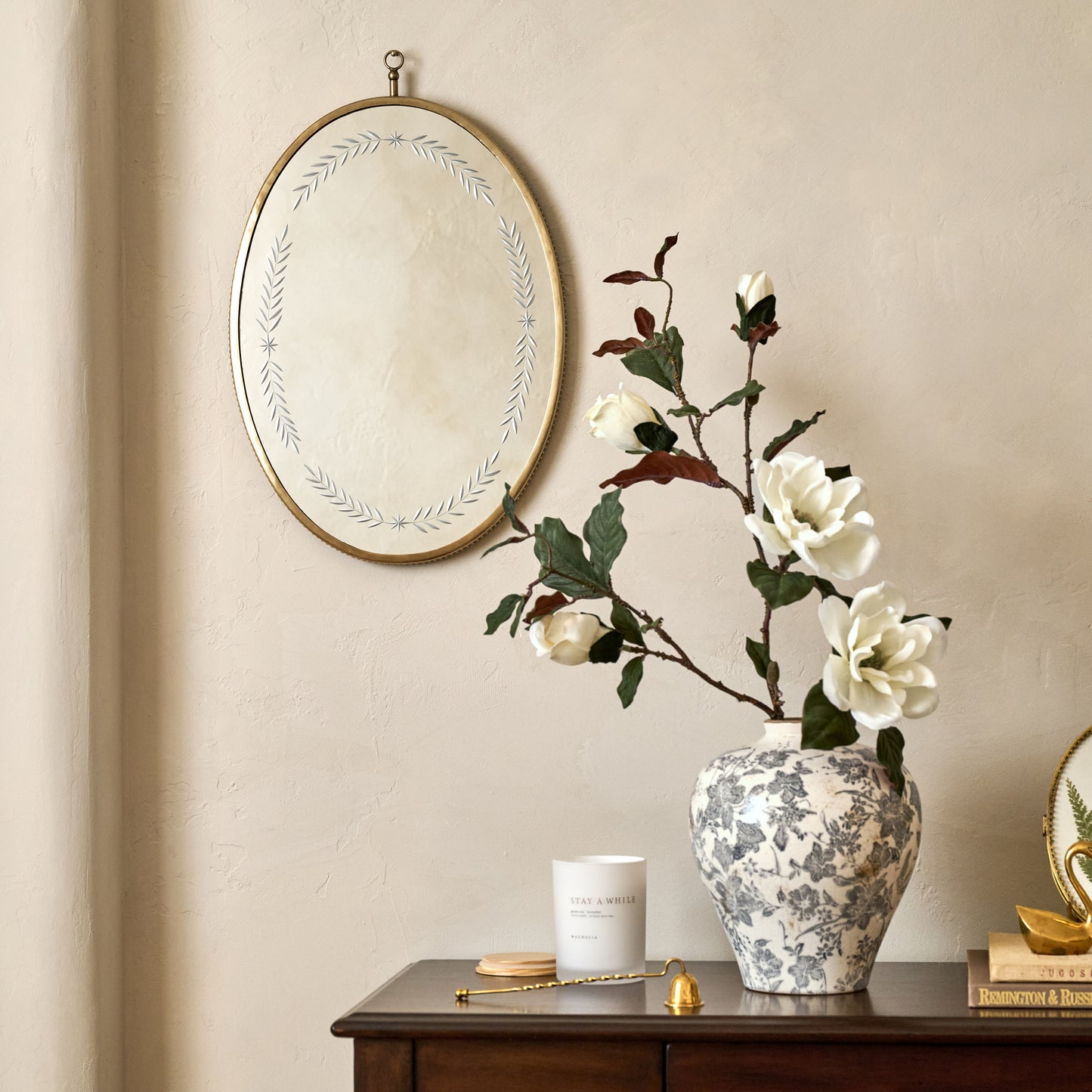 Juliet Etched Oval Mirror shown hung on wall