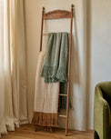 Gloria Carved Wood and Brass Decorative Ladder shown with blankets
