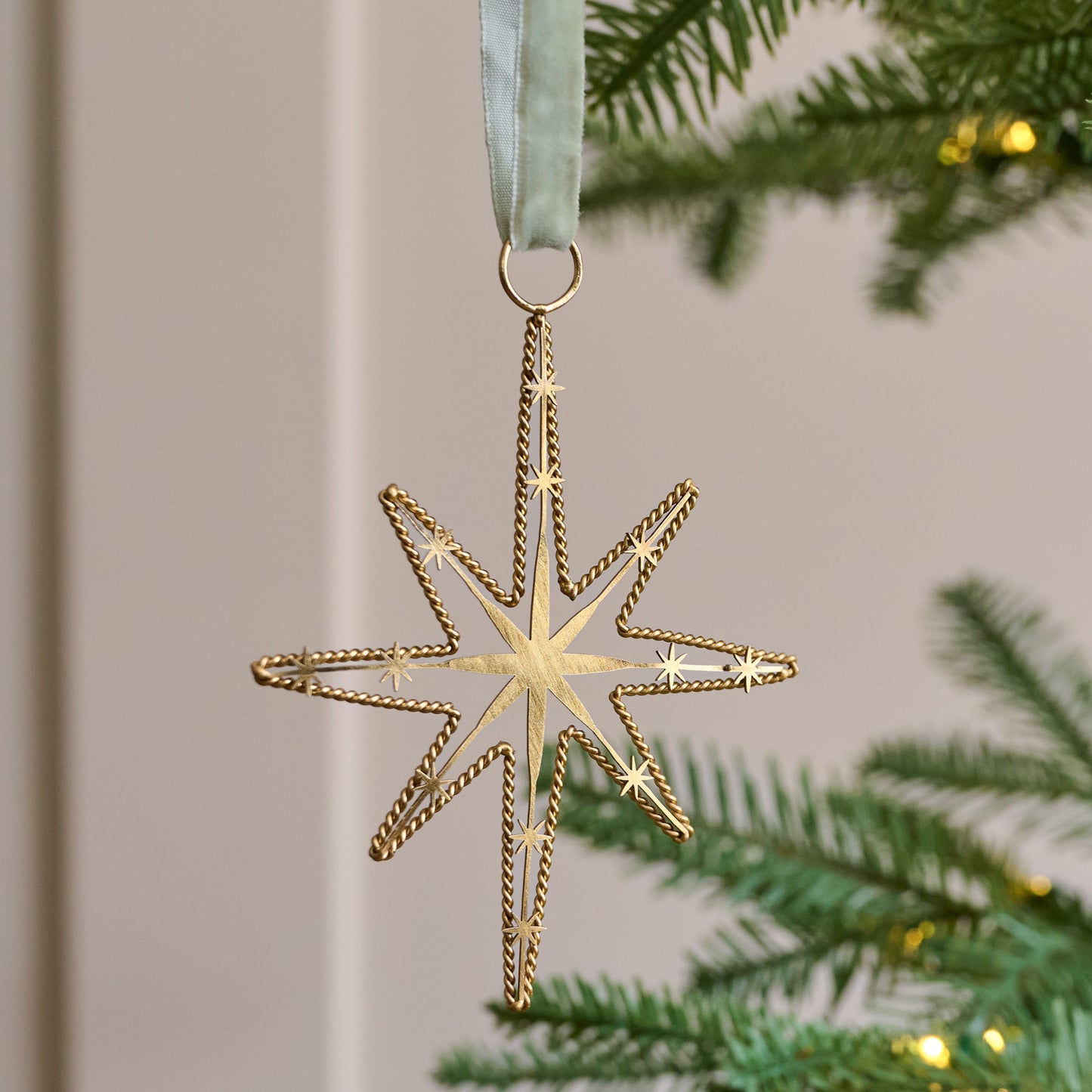 Twisted Brass Star Ornament shown on tree