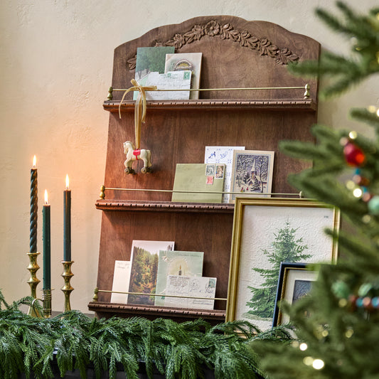 Gloria Carved Wood and Brass Display Shelf shown styled with seasonal decor