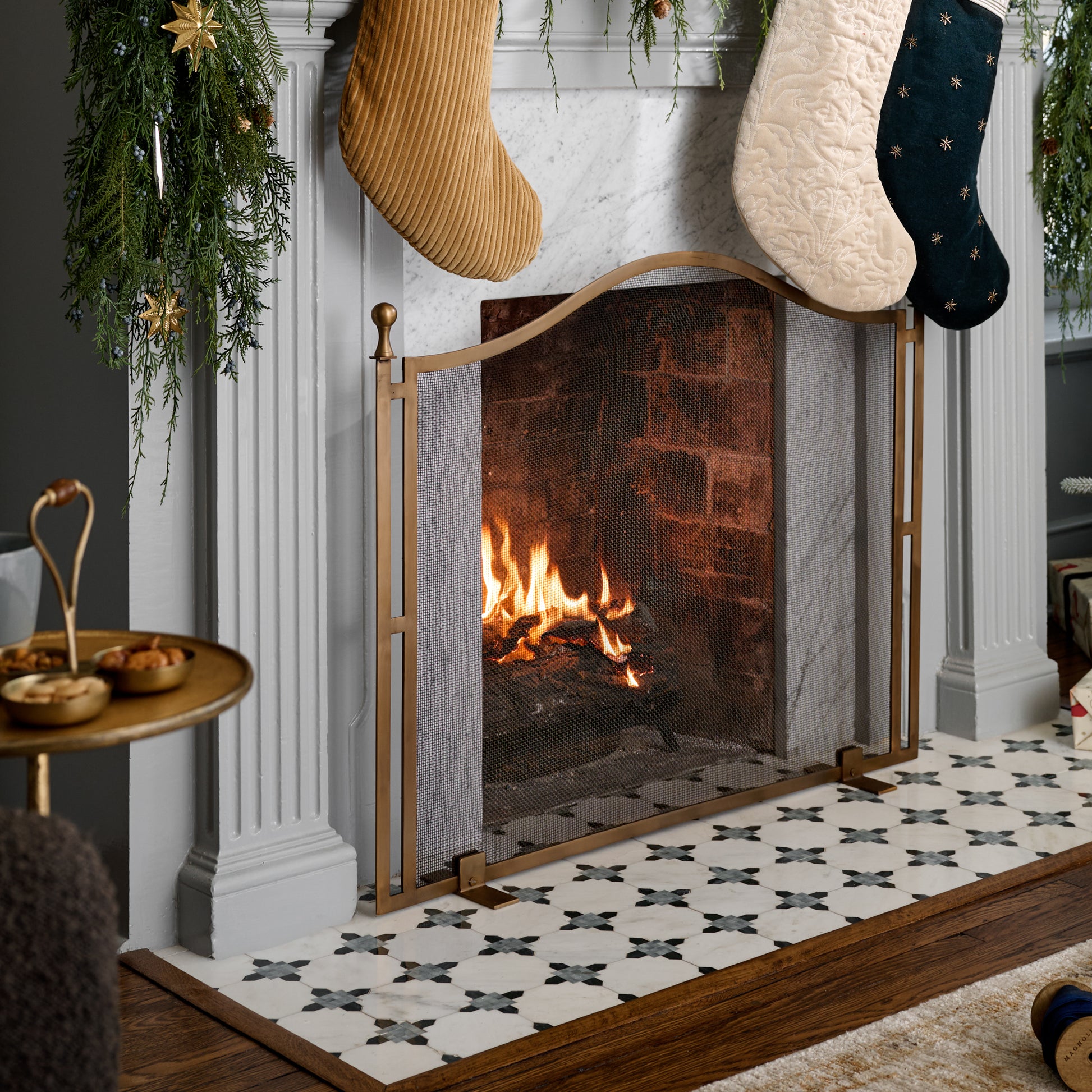 Shepherd Brass Fireplace Screen shown in front of fireplace