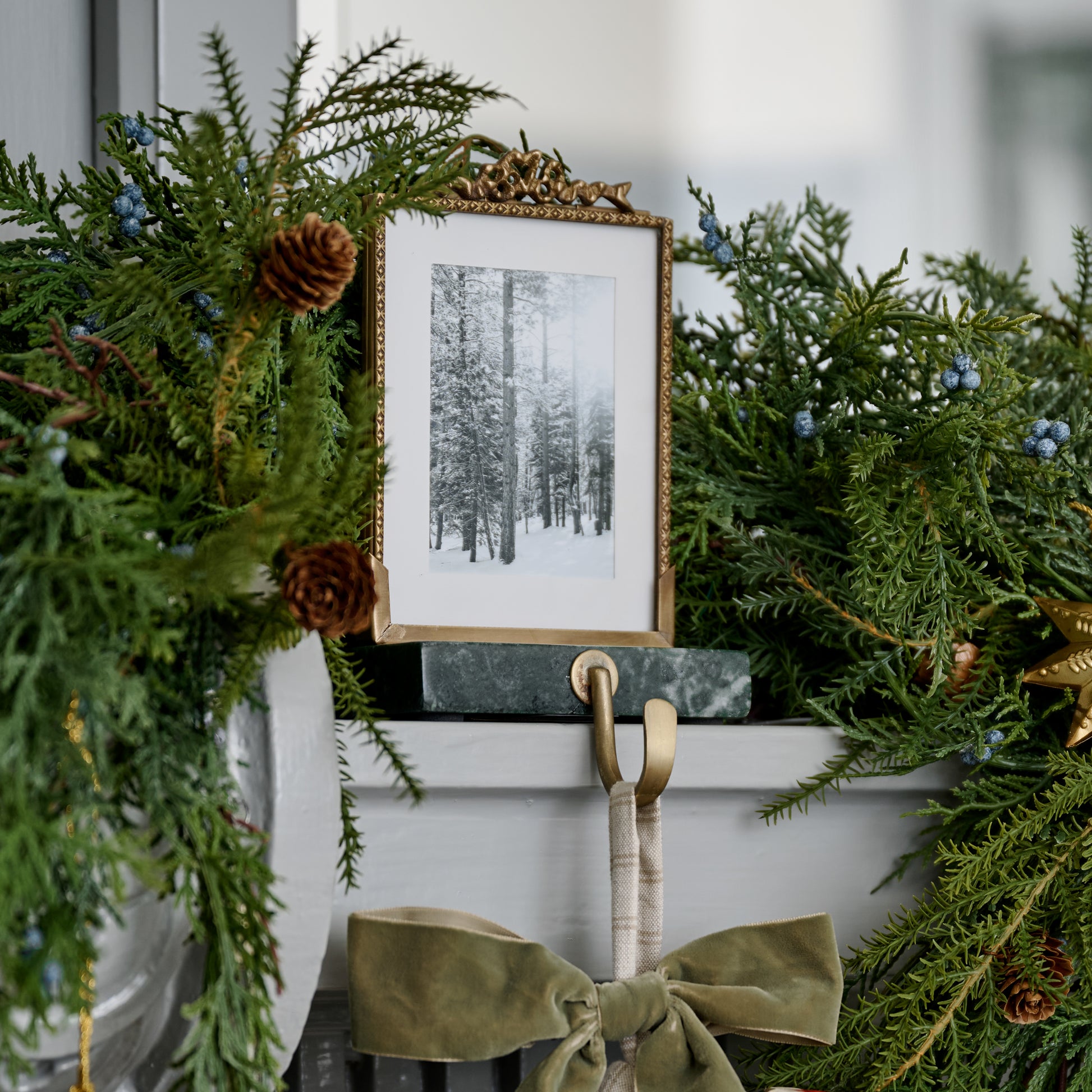 Green Marble Noelle Antique-Inspired Photo Frame Stocking Holder shown on mantel