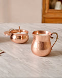 Antique Copper Creamer shown on counter with matching sugar canister