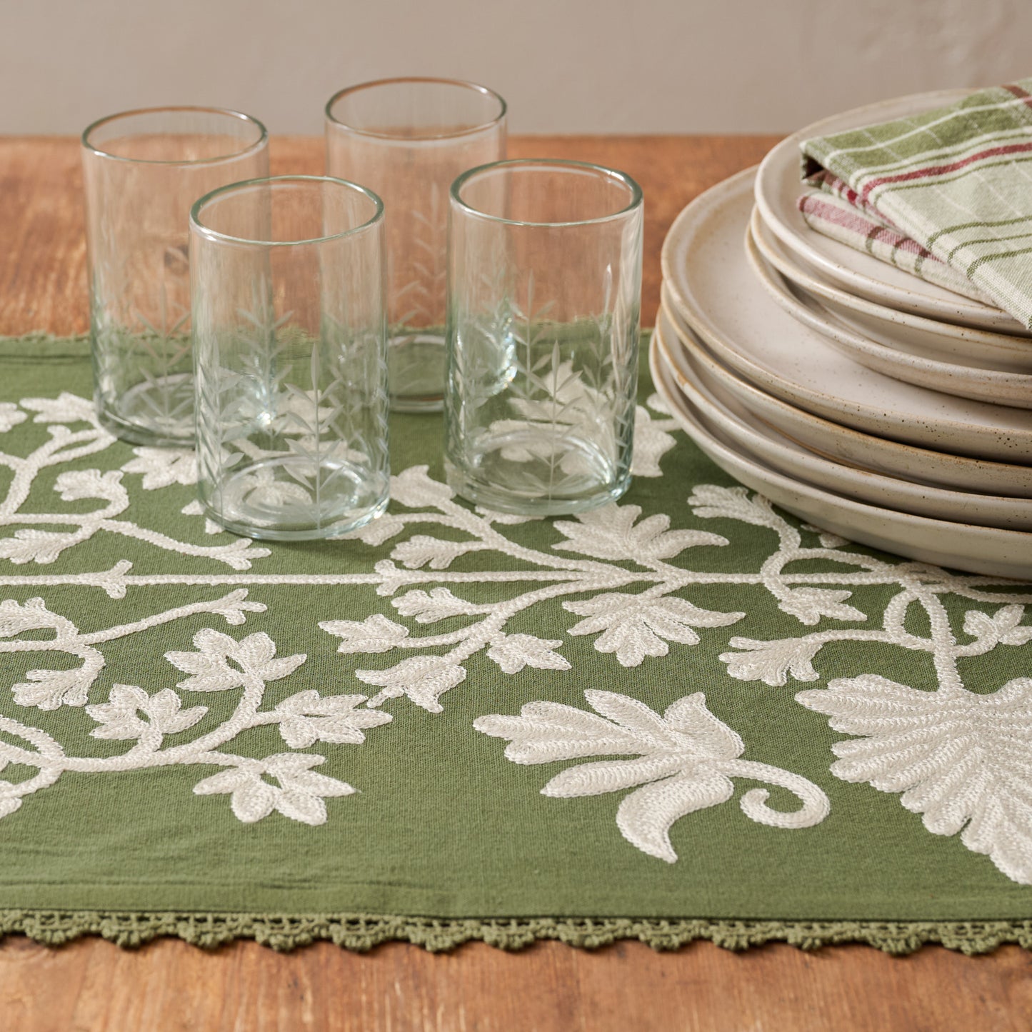 Winter Moss Embroidered Table Runner shown on table with etched glasses