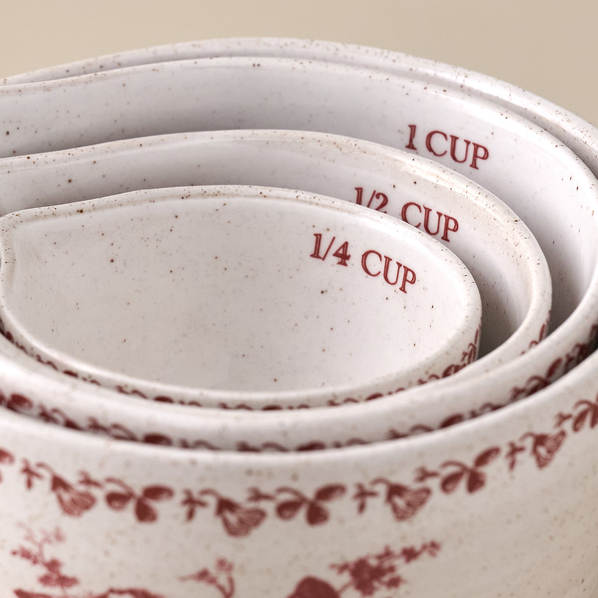 Heirloom Garden Scarlett Floral Measuring Cup Set shown stacked inside each other up close