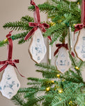 Enchanted Forest Tile Ornaments with red velvet ribbons and animal sketches