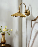 Brass Pleat Plug-in Sconce in bedroom next bed and nightstand