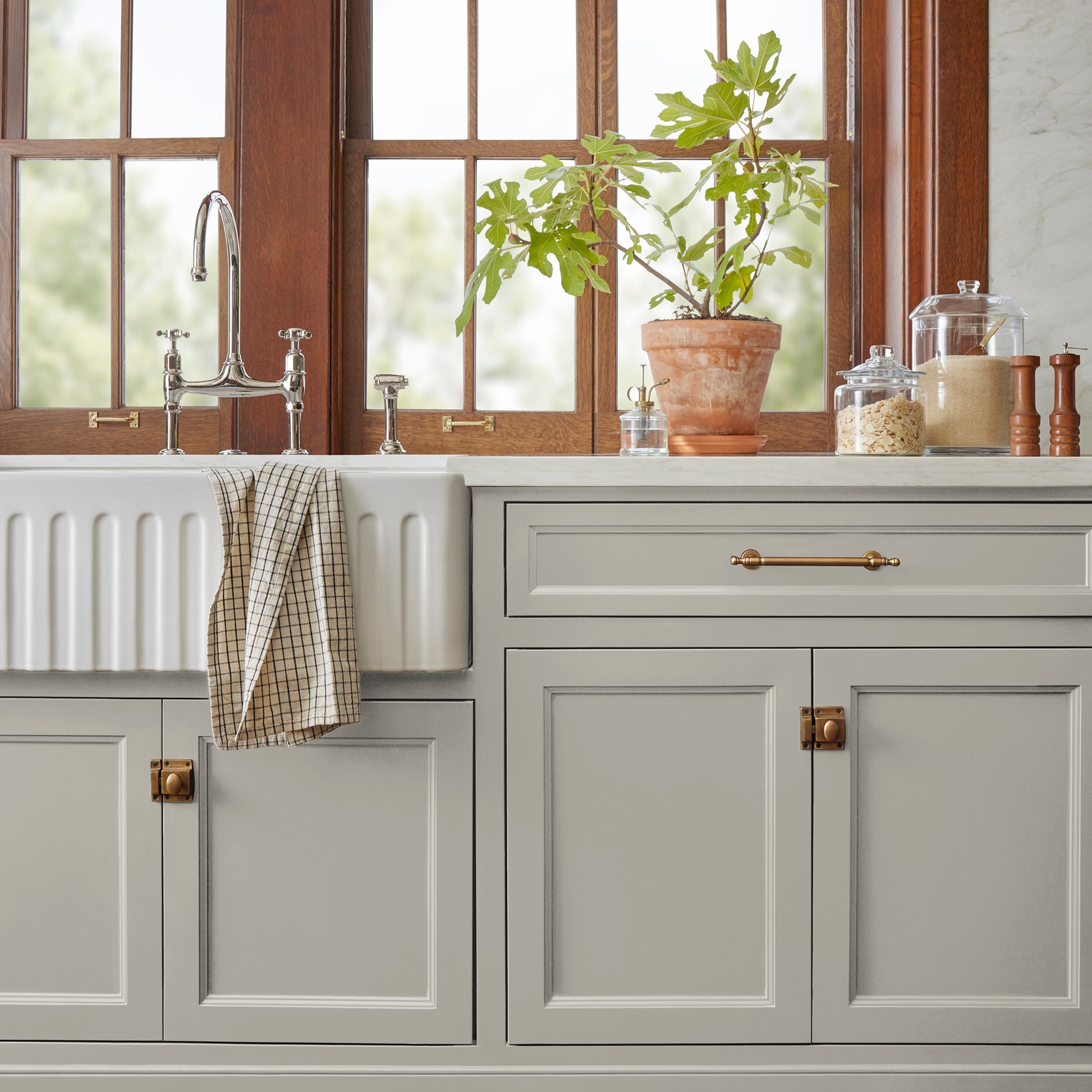 medium warm grey paint named sunday stroll shown painted on kitchen cabinet