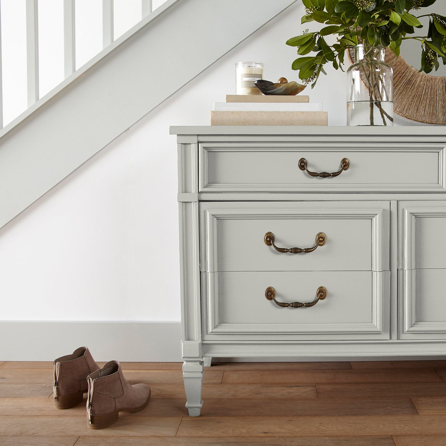 Warm white with a light beige tint named one horn white shown painted on entryway cabinet