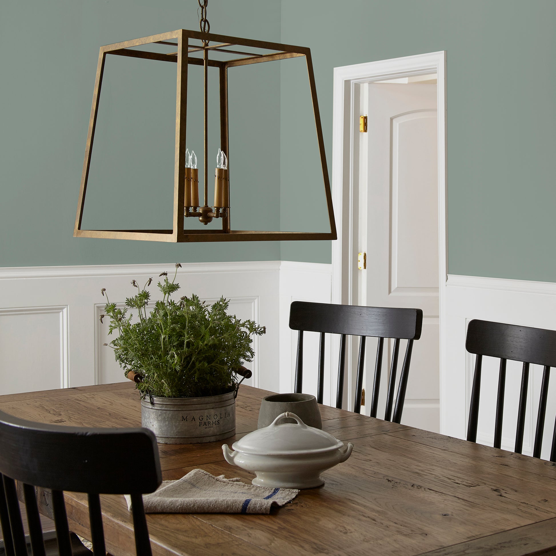 Deep gray with hues of rich blue and sage green interior paint named silverado sage shown painted on dining room wall