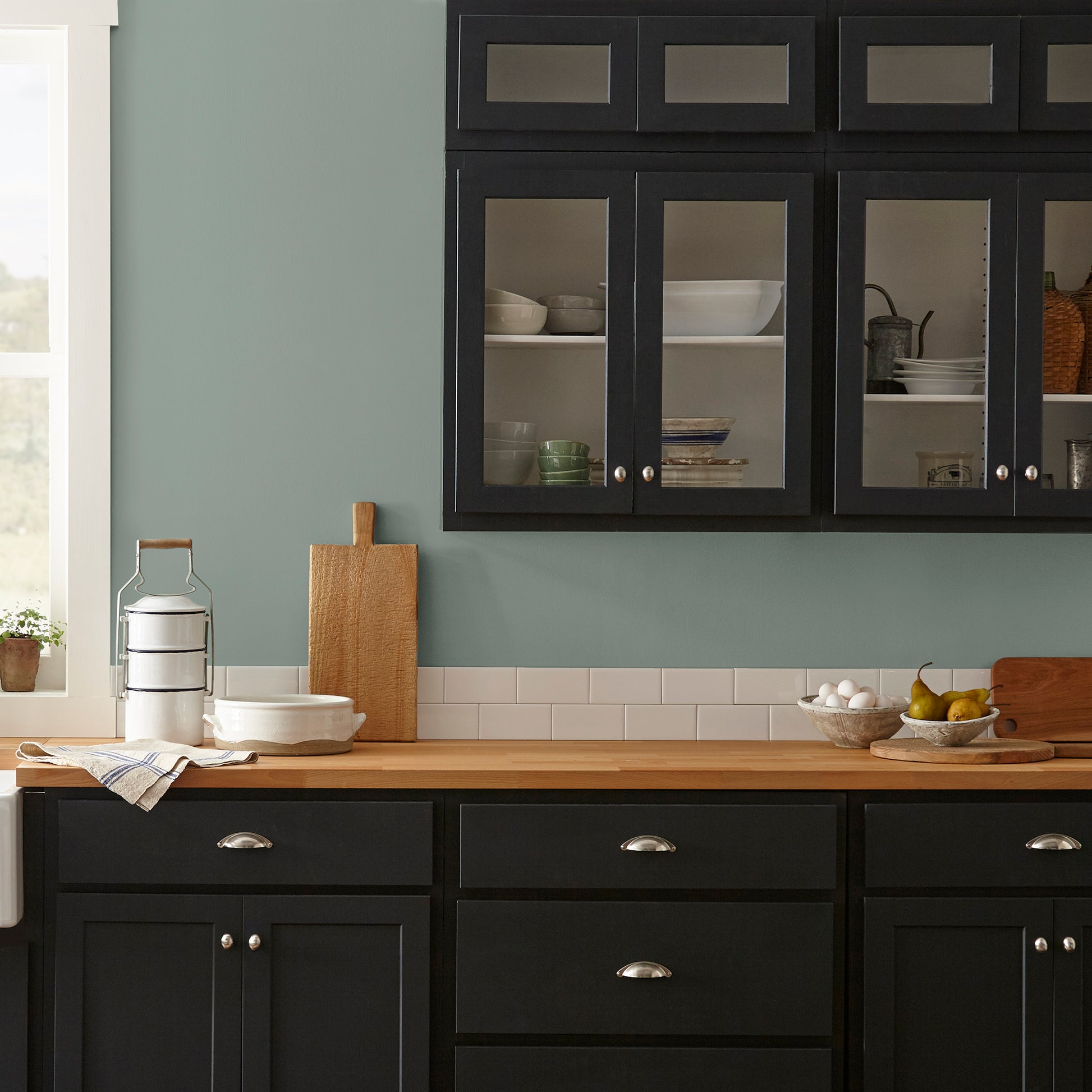 Deep gray with hues of rich blue and sage green interior paint named silverado sage shown painted on kitchen wall