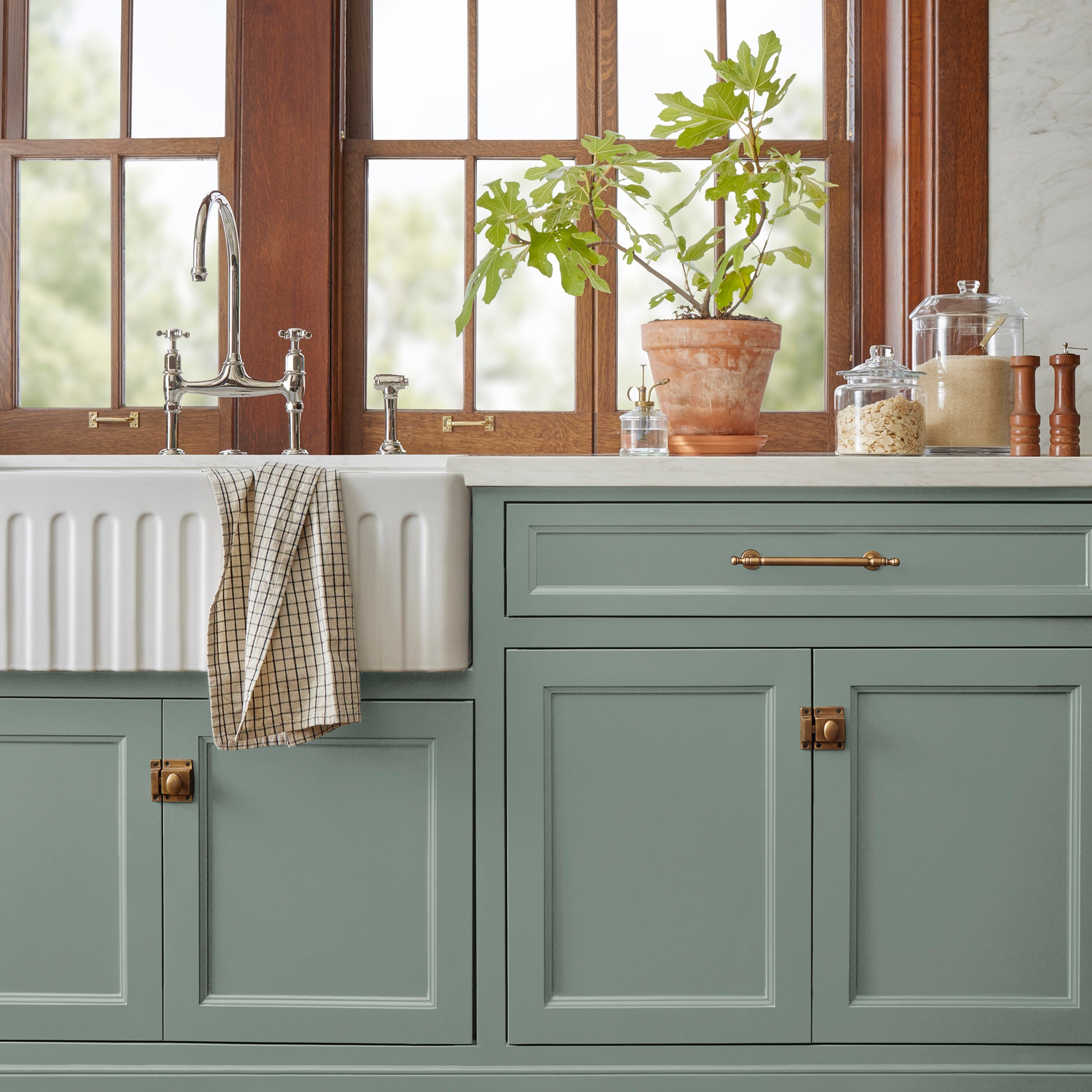 Deep gray with hues of rich blue and sage green paint named silverado sage shown painted on kitchen cabinet