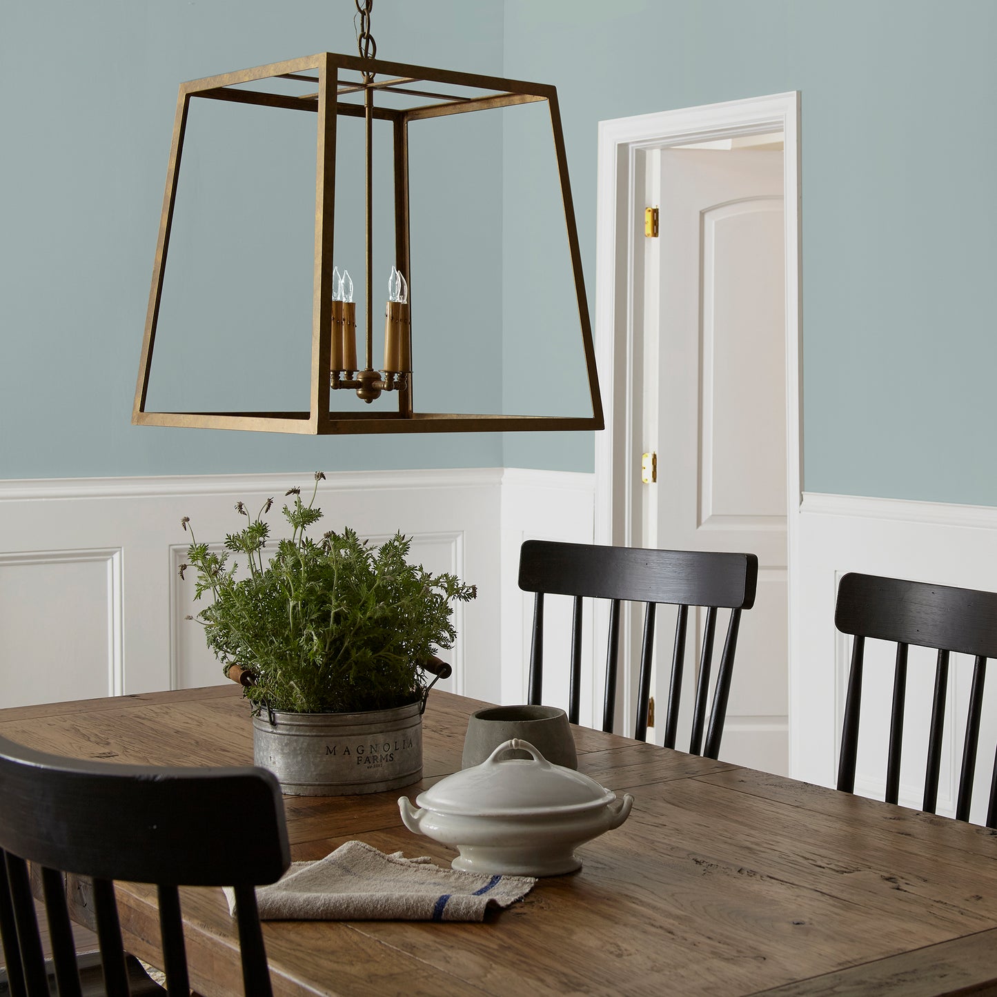 muted grey blue interior paint named rainy days shown painted on dining room wall