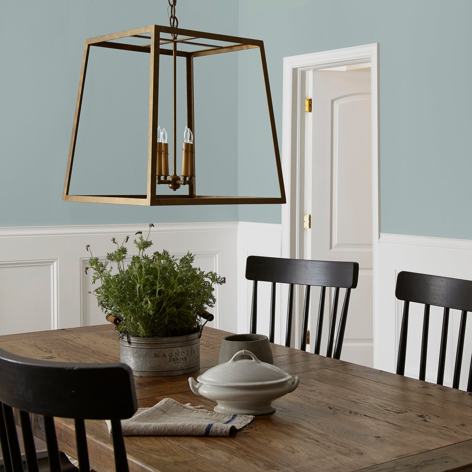 muted grey blue interior paint named rainy days shown painted on dining room wall