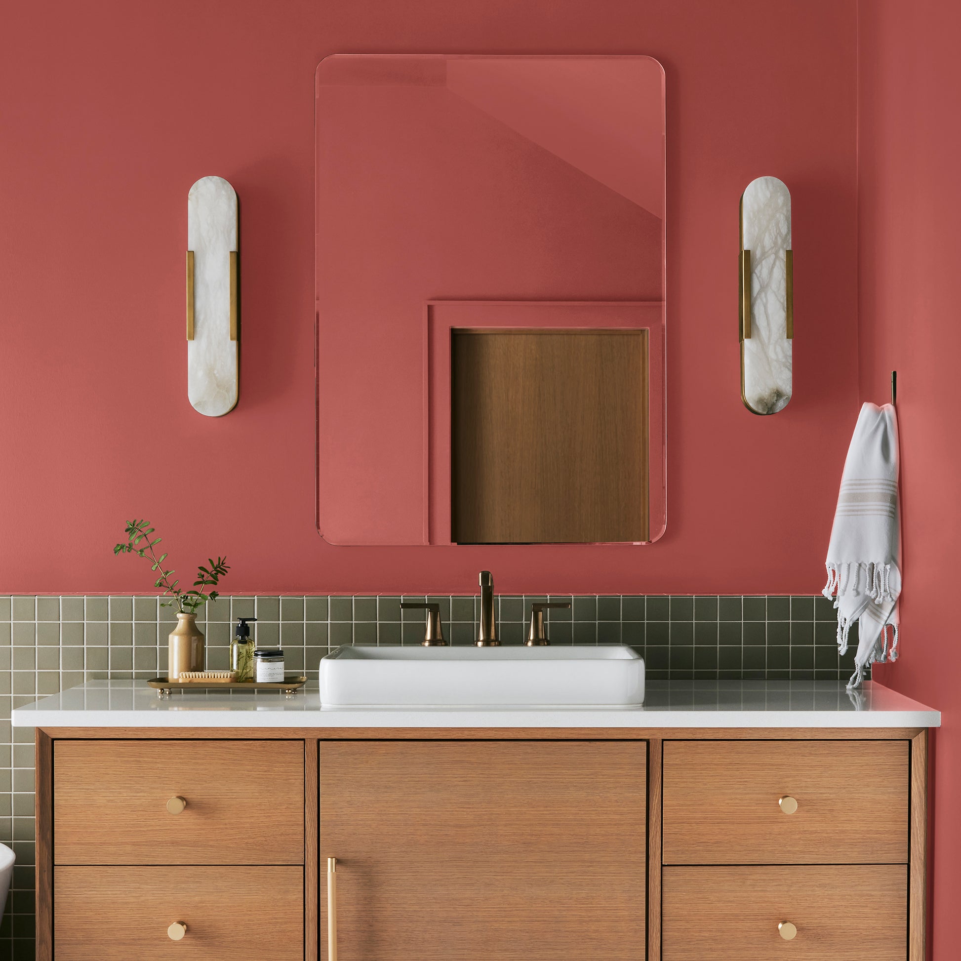 vibrant red with orange undertones interior paint named ripened tomato shown painted on bathroom wall