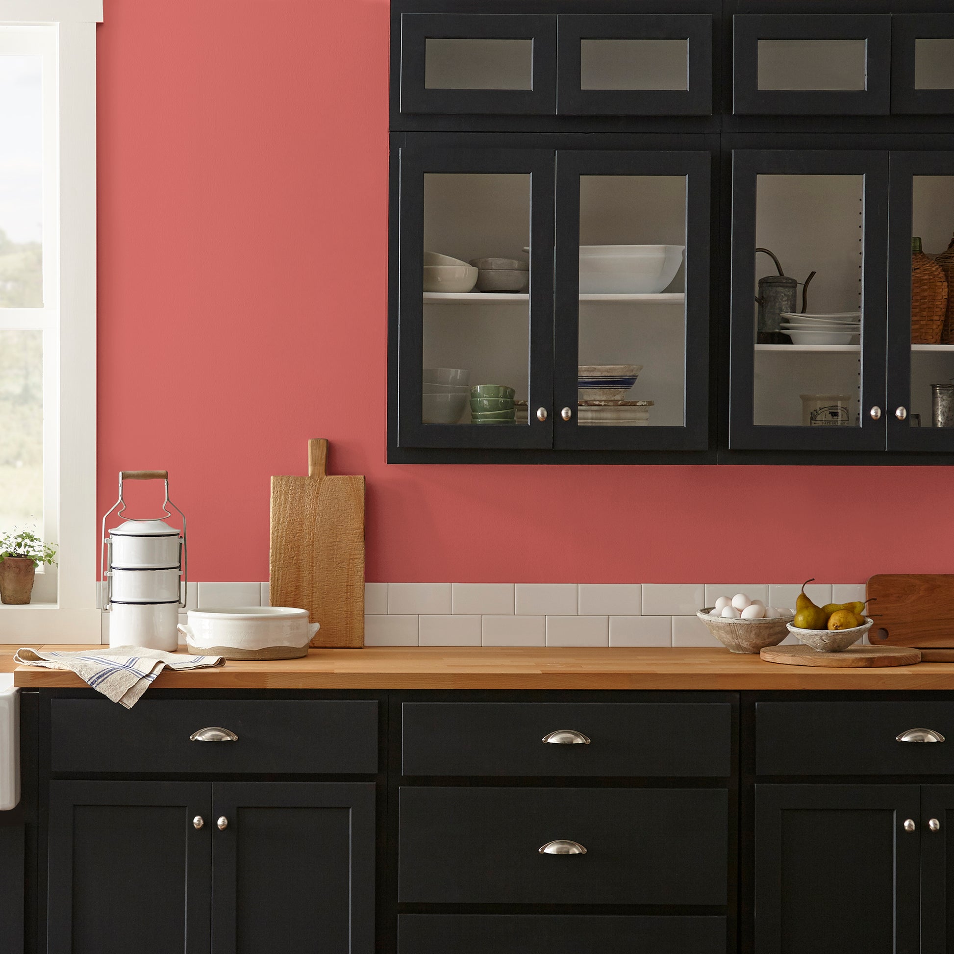 vibrant red with orange undertones interior paint named ripened tomato shown painted on kitchen wall