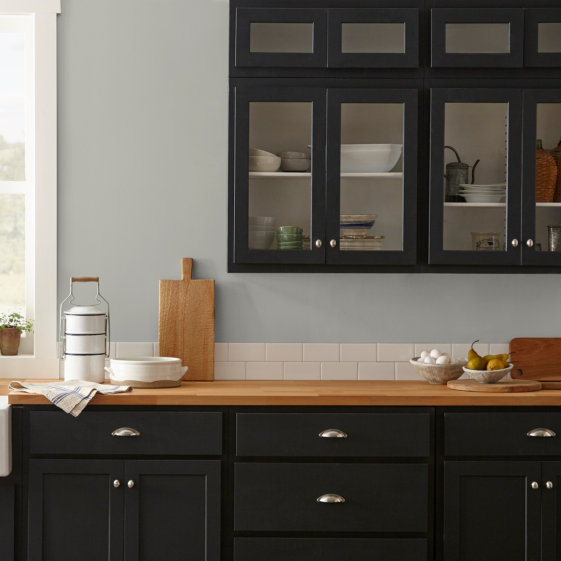 pure grey with a tan undertone interior paint named cupola shown painted on kitchen wall