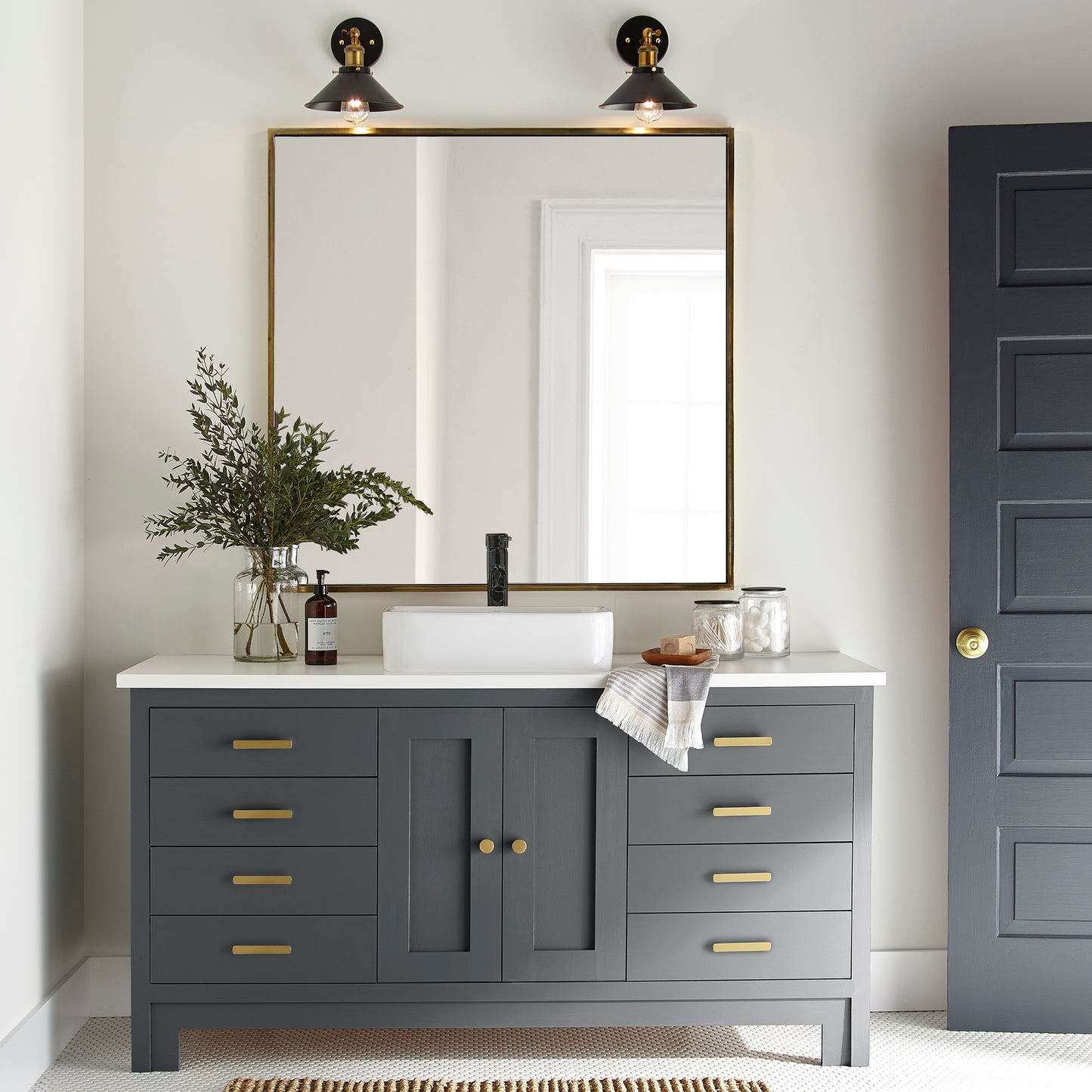A dark chalkboard black with blue undertones paint named Blackboard shown painted on bathroom cabinet.