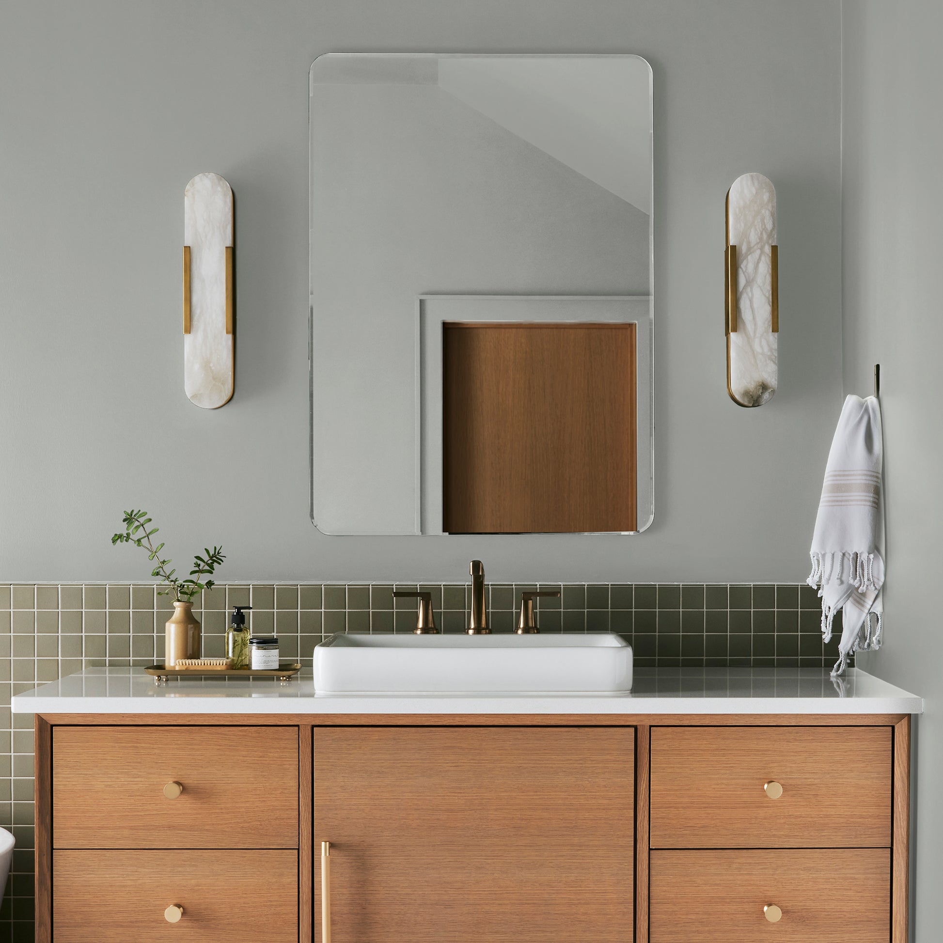 Silver gray tinted with sky blue interior paint named wedding band shown painted on bathroom wall