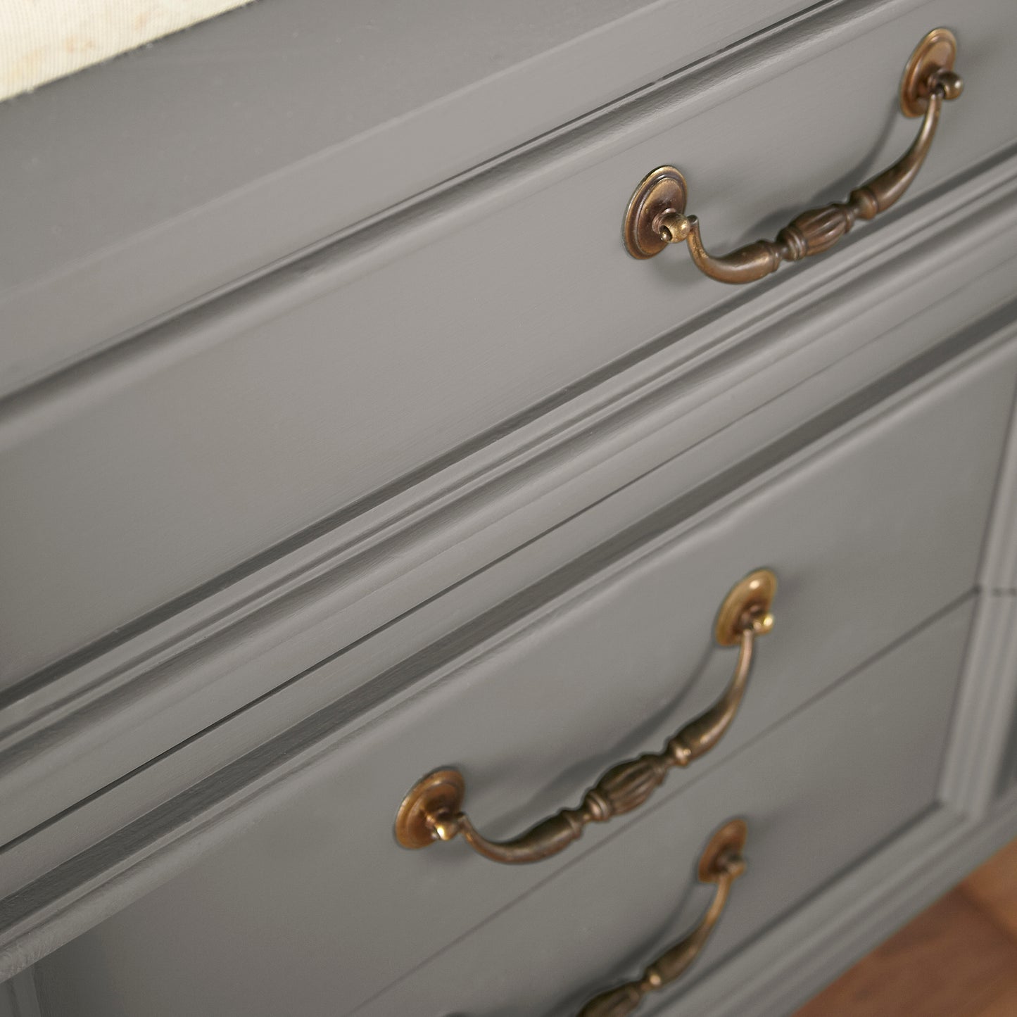 dark grey with olive-brown undertones paint named garden trowel shown painted on cabinet